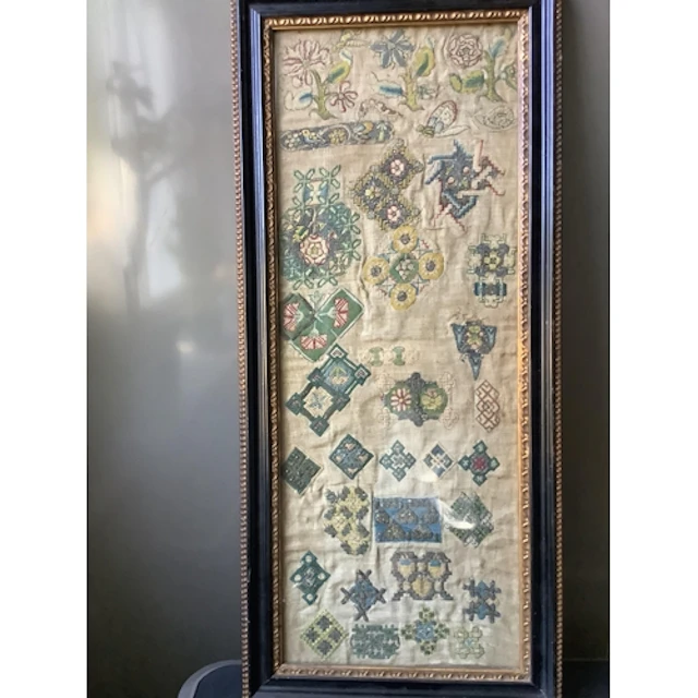 A rare early 17th century spot motif sampler. Worked on fine...