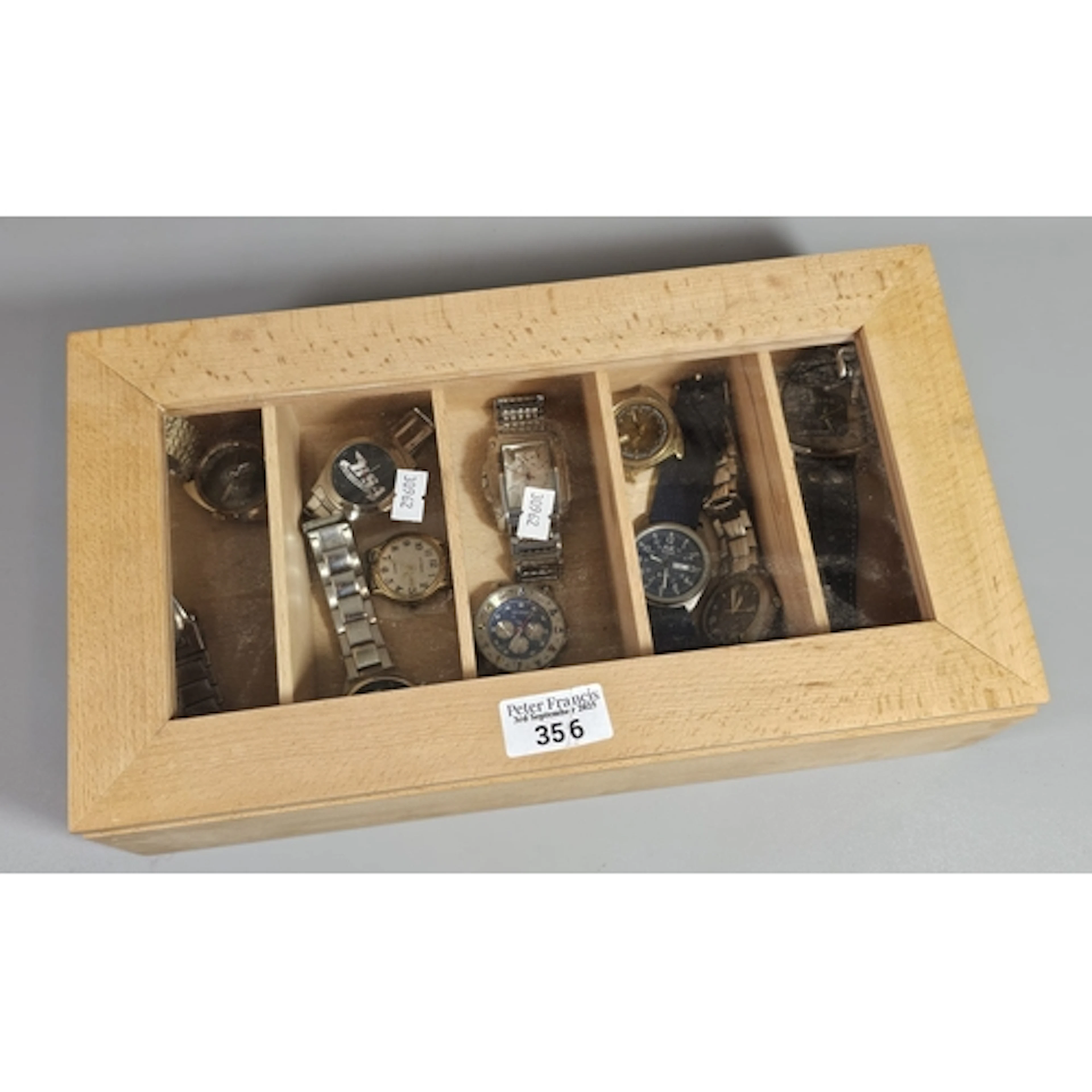 Display case comprising a collection of dress watches to inc...