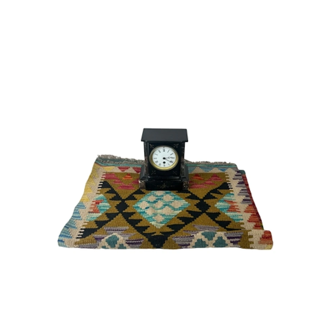 A GEOMETRIC PATTERN RUNNER AND A VICTORIAN BLACK SLATE MANTE...