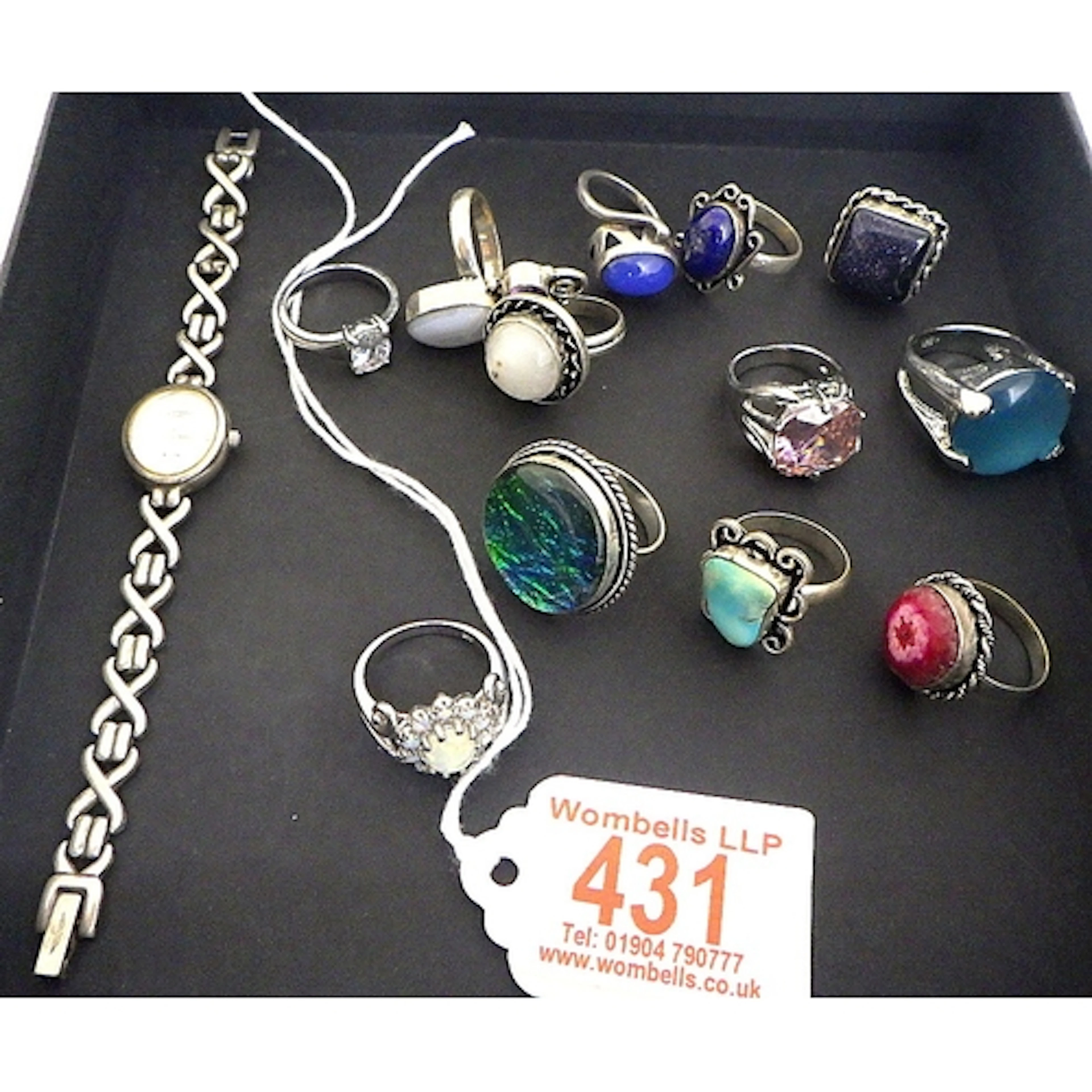 A group of silver (925) and white metal dress rings together...
