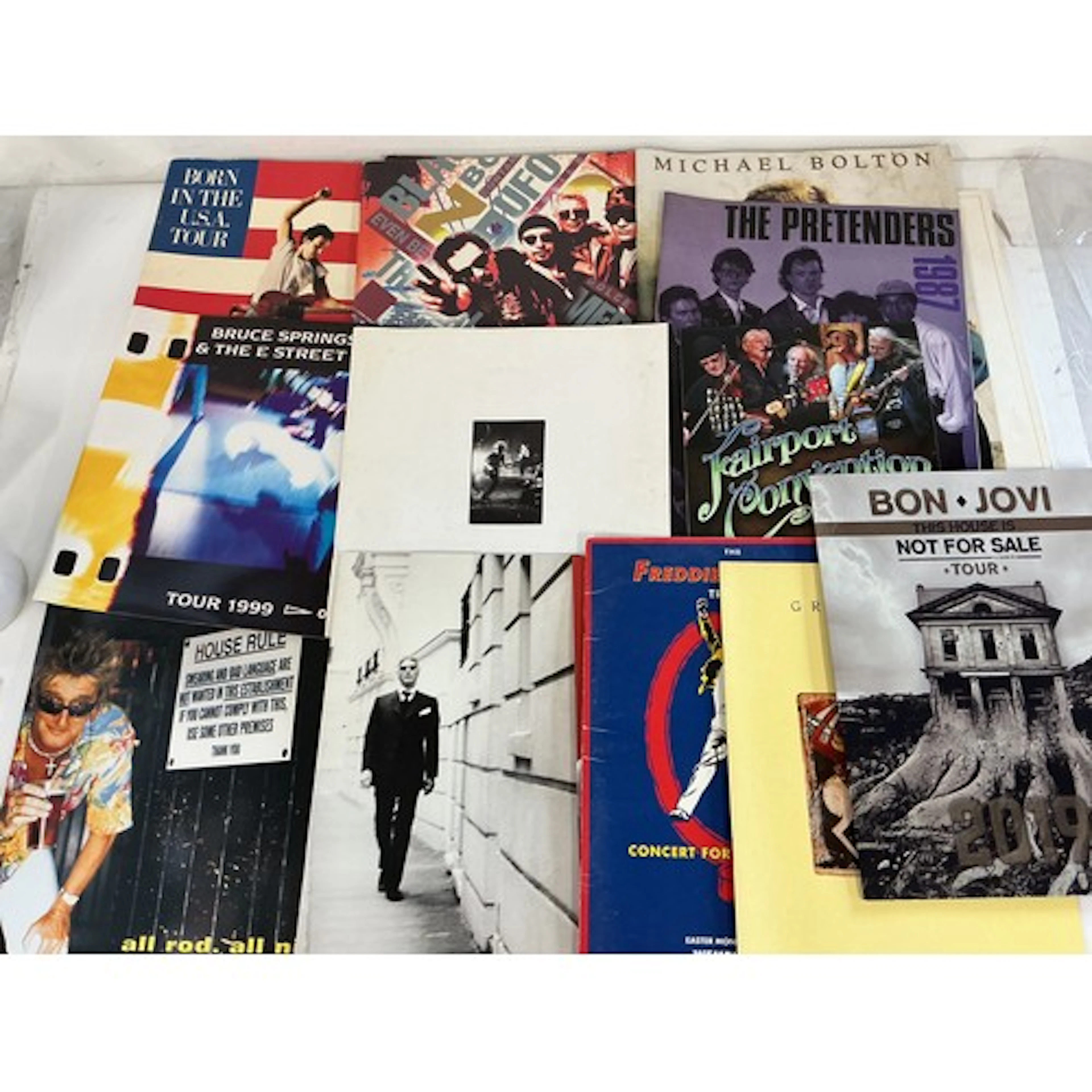 A collection of various tour programs and calendars. Artists...