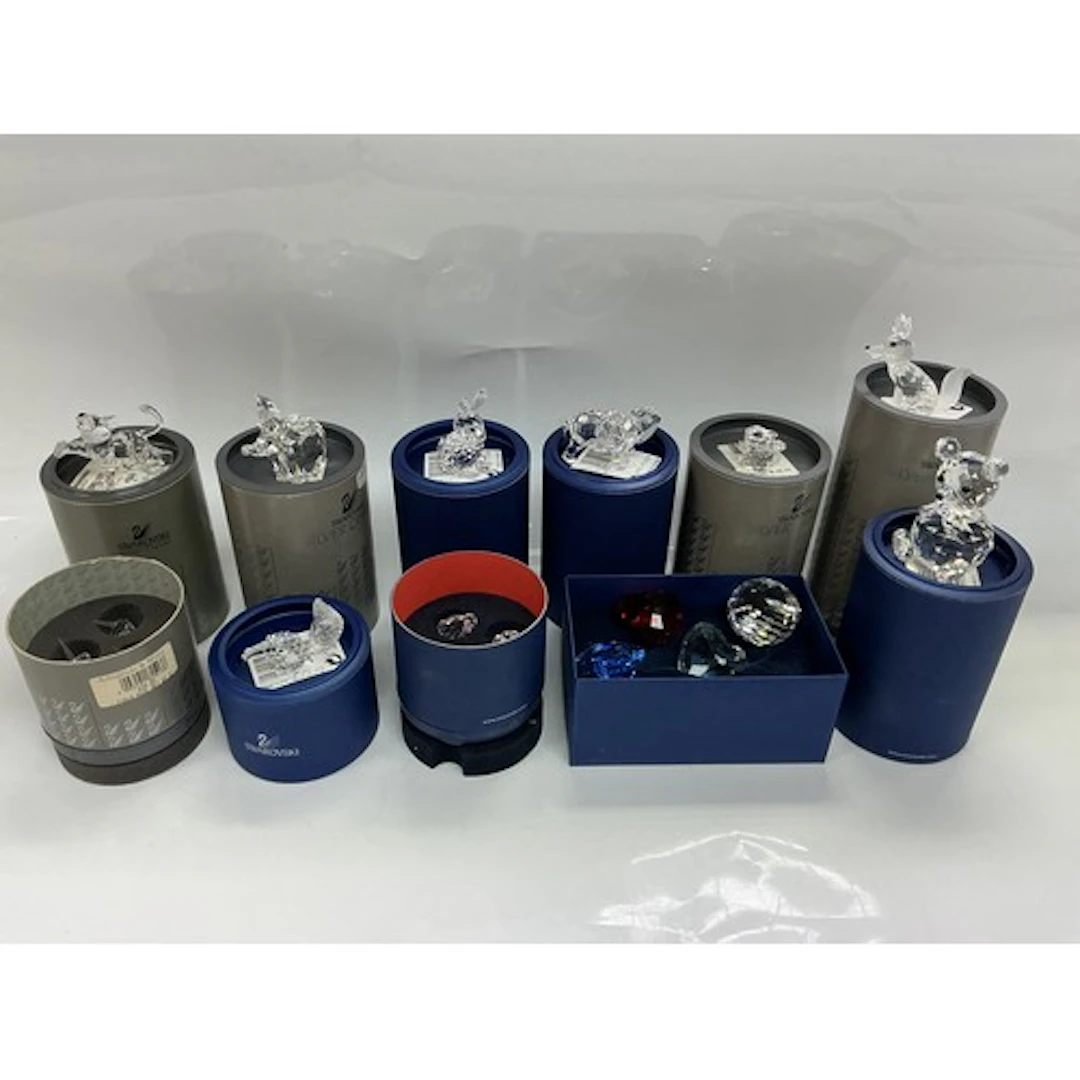 A collection of boxed Swarovski items comprising various ani...