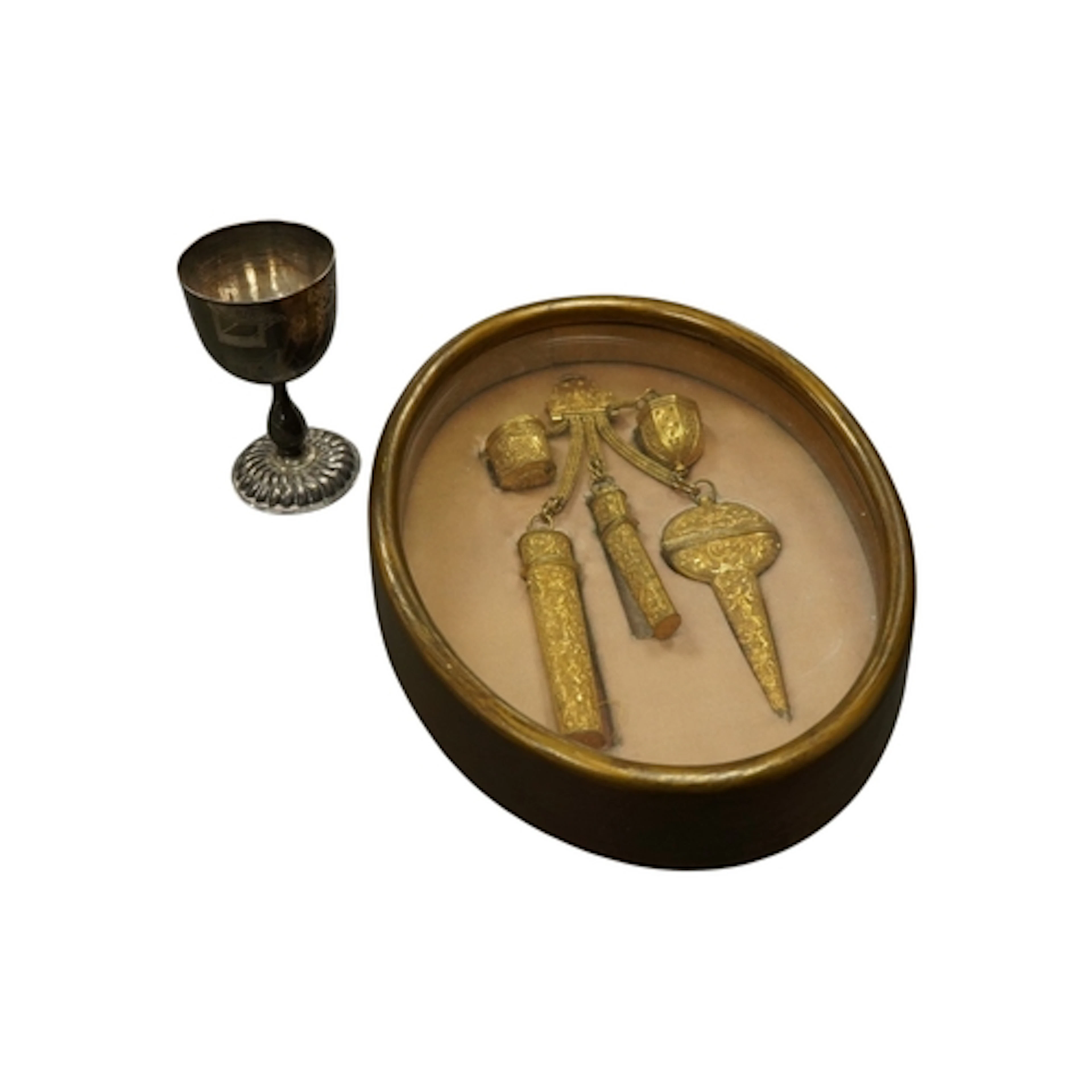A gold plated chatelaine housed in a fitted cased along with...