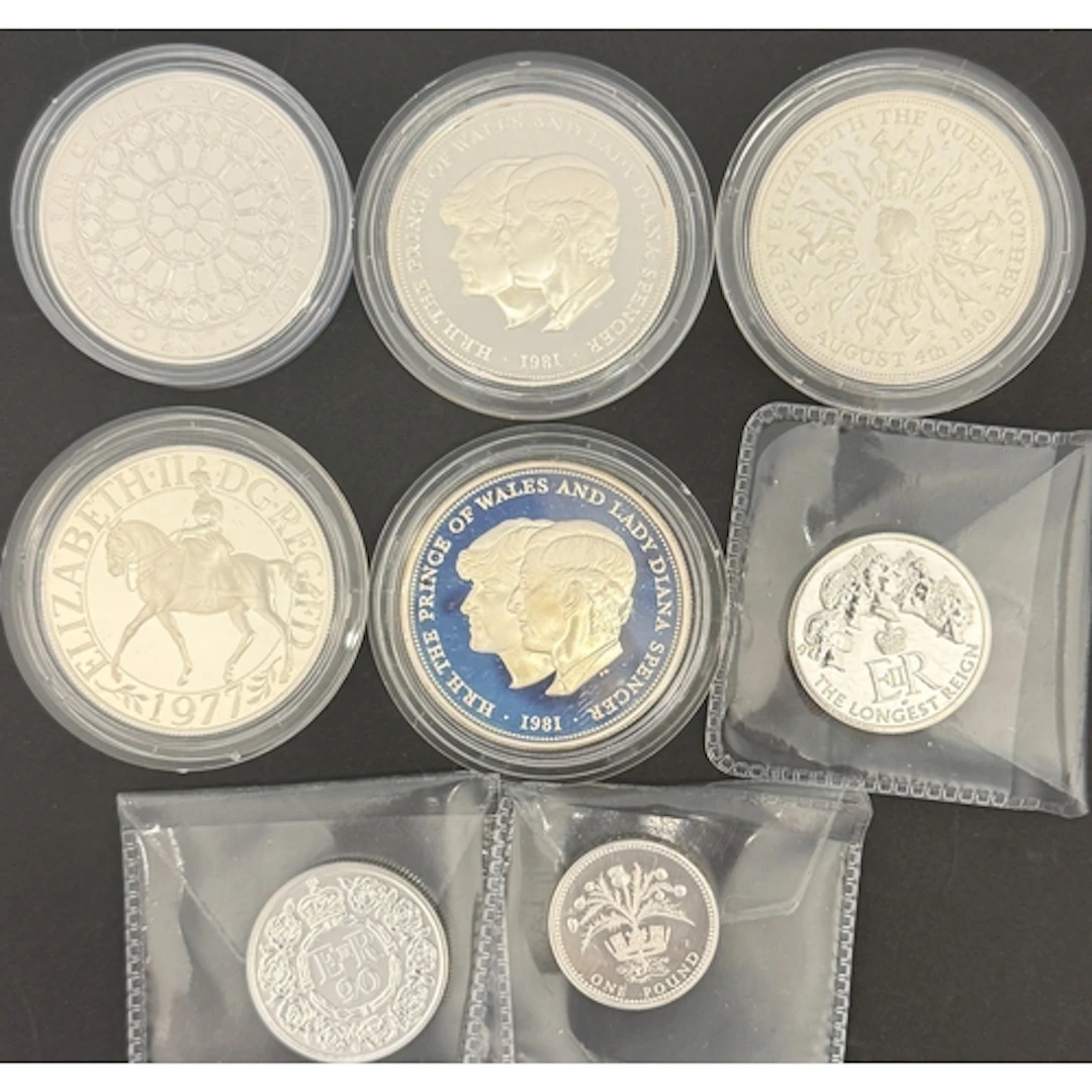 A group of eight UK QEII silver coins, comprising 1977 Silve...