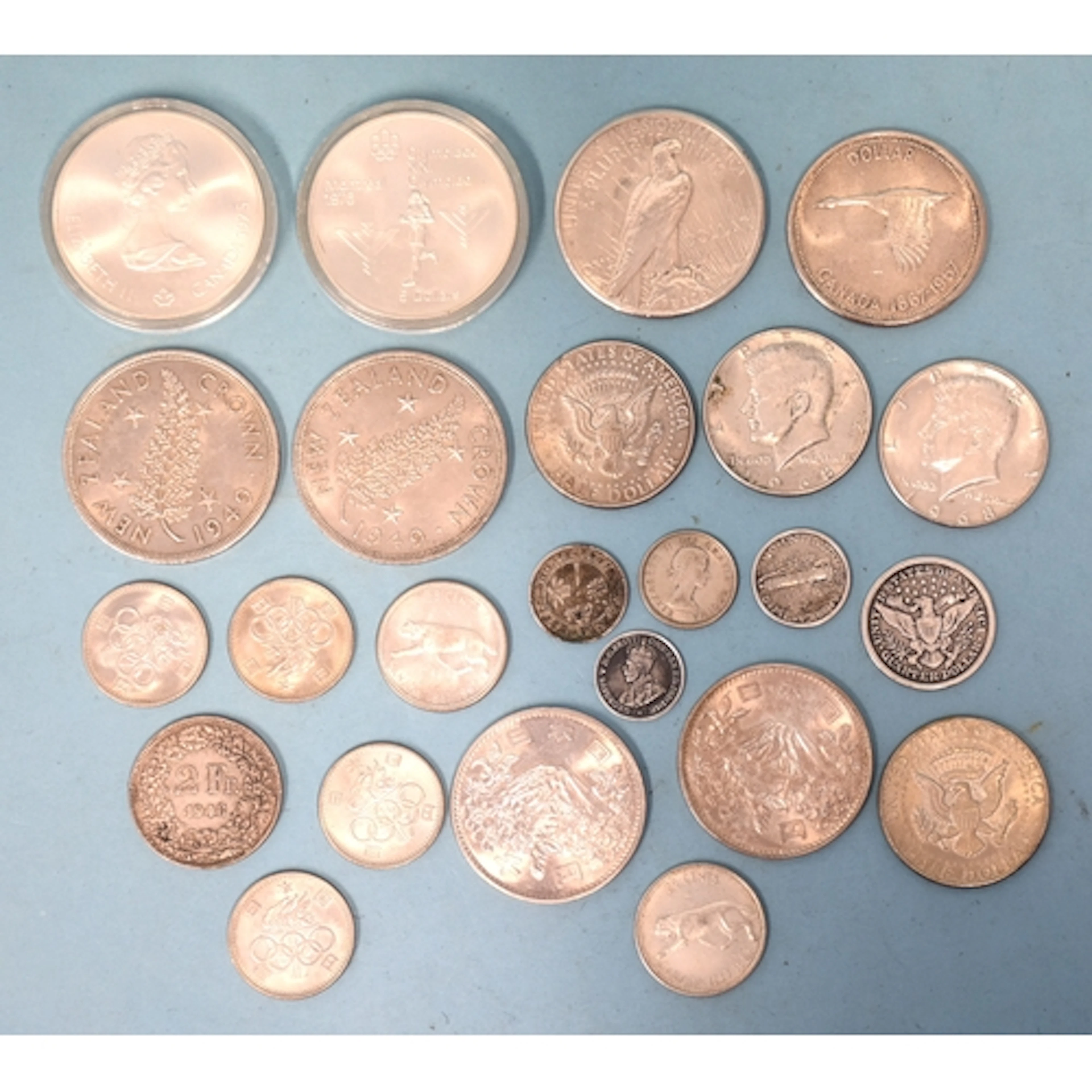 A collection of various foreign silver coins, including USA ...