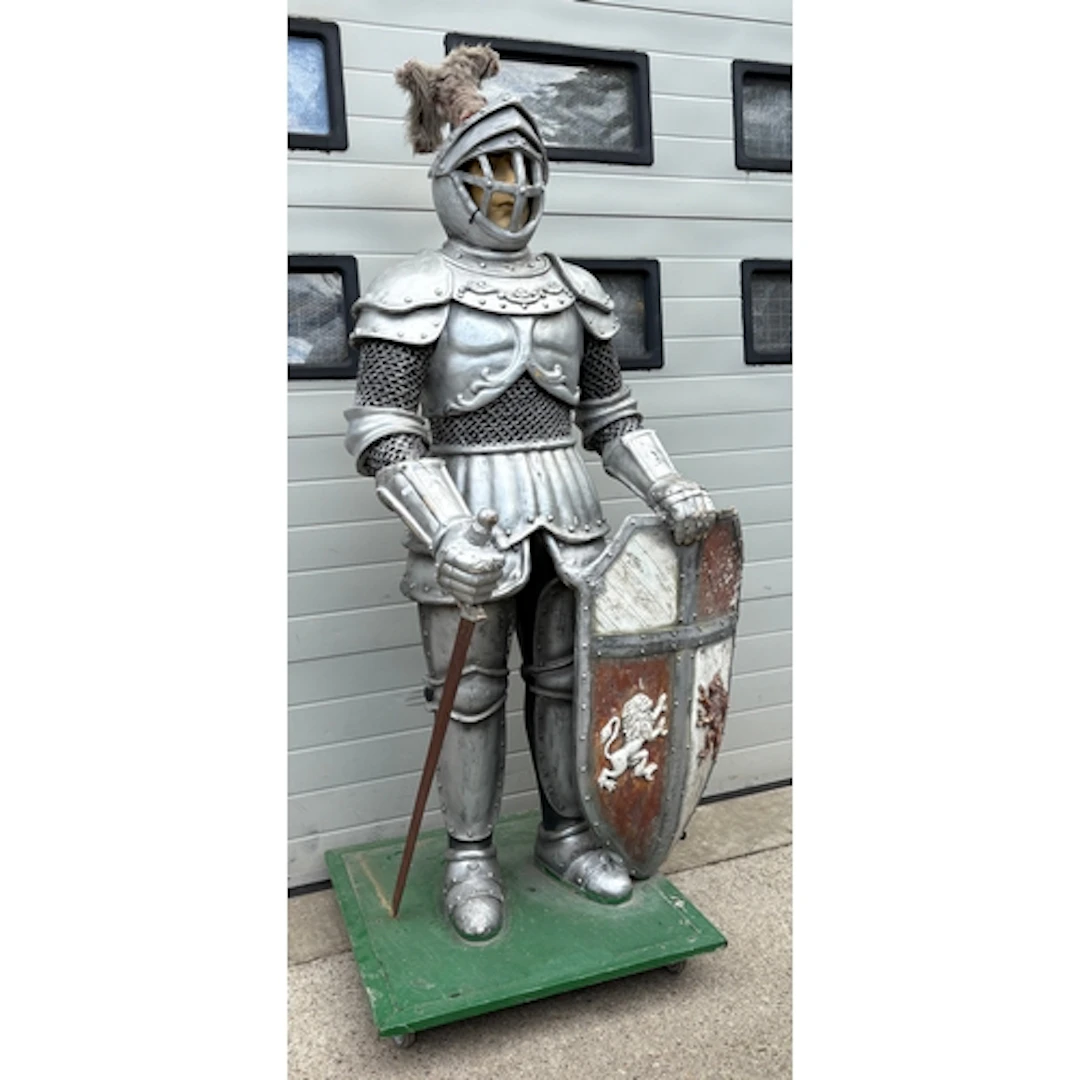 A life-size silver-finish medieval knight prop with a shield...