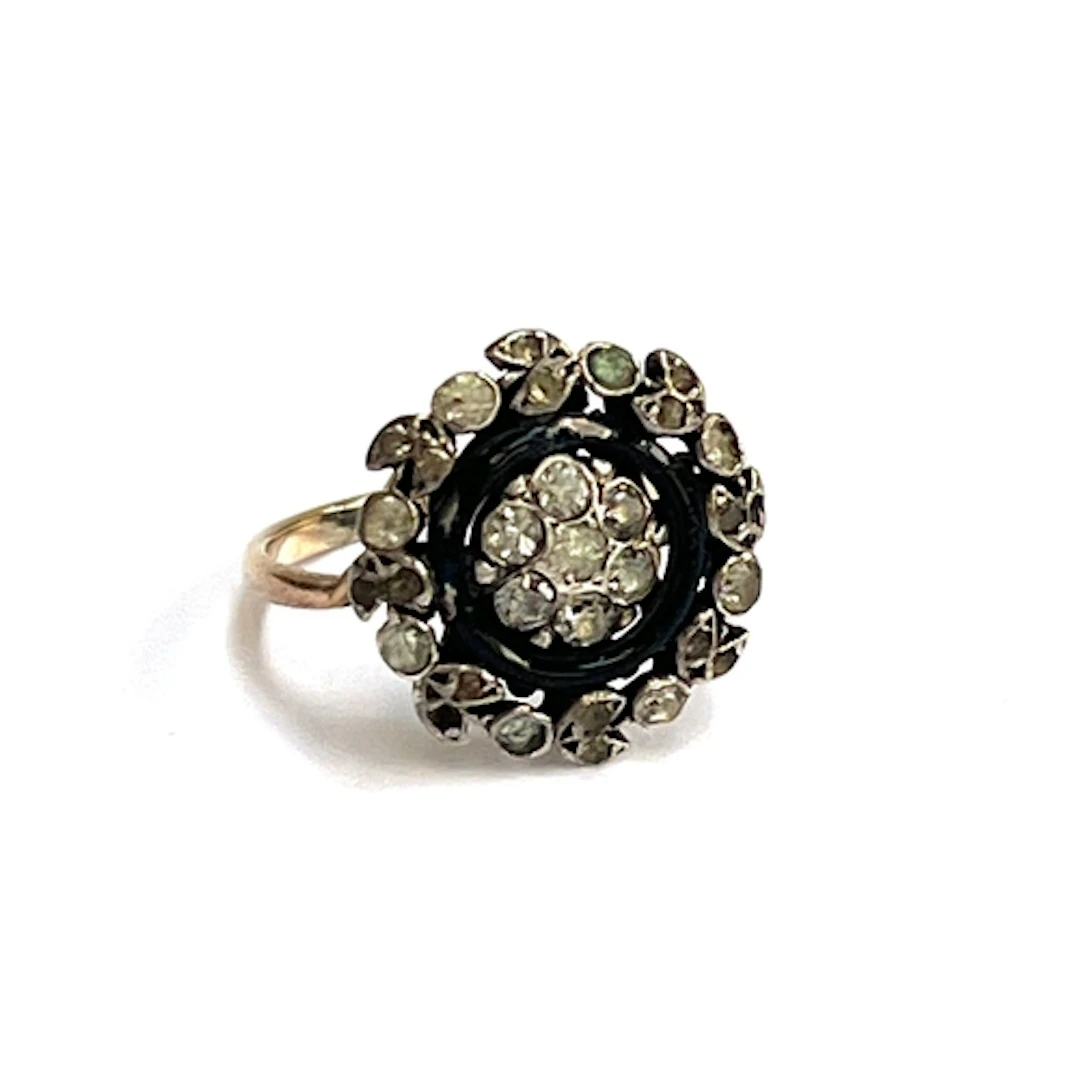 An Art Deco gold and silver ring set with a paste and black ...