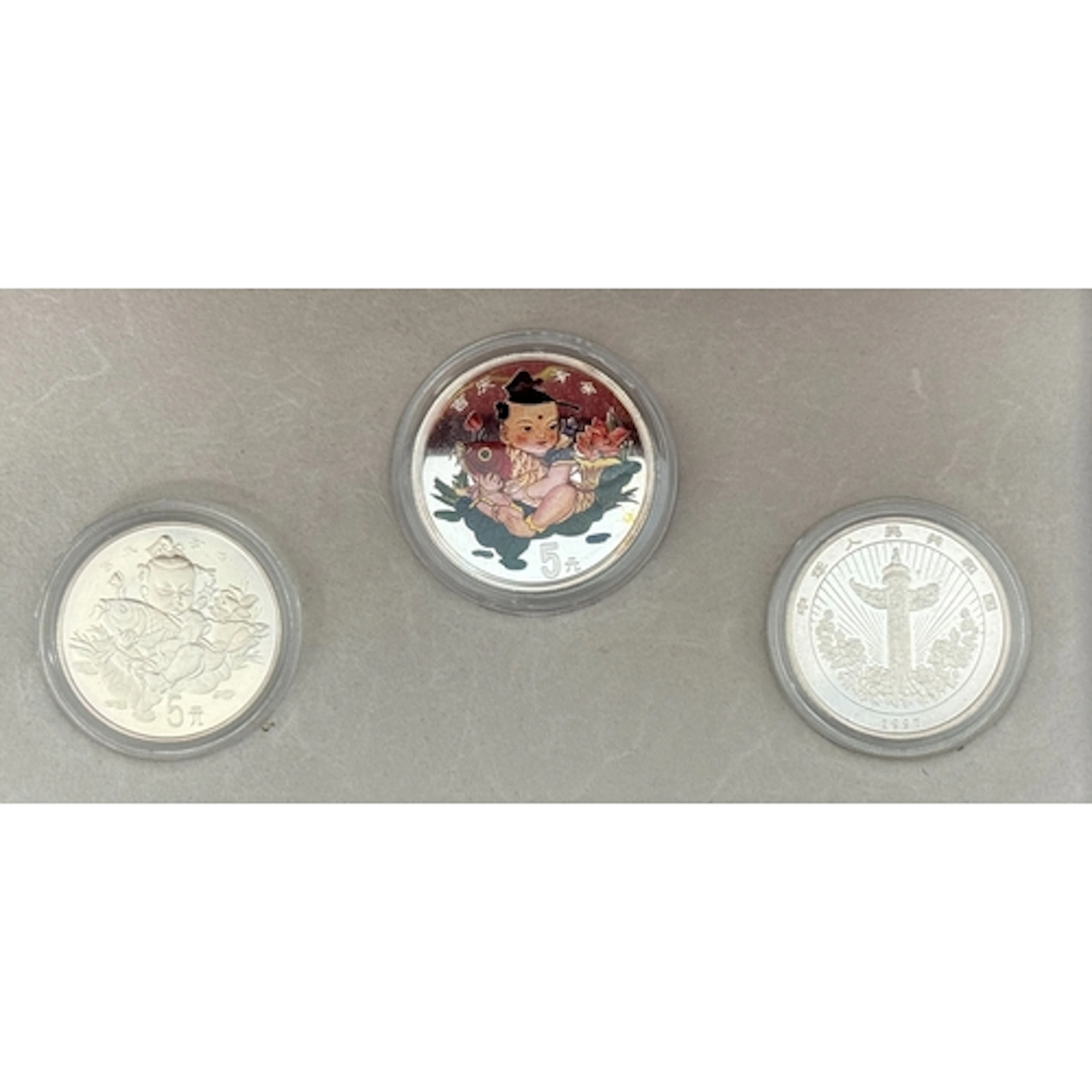 The People’s Bank of China 1997 Lucky Silver three-coin set,...