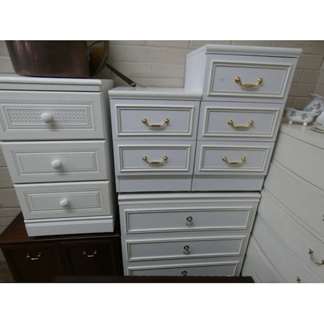 A white painted tall boy chest of drawers together with a wh...
