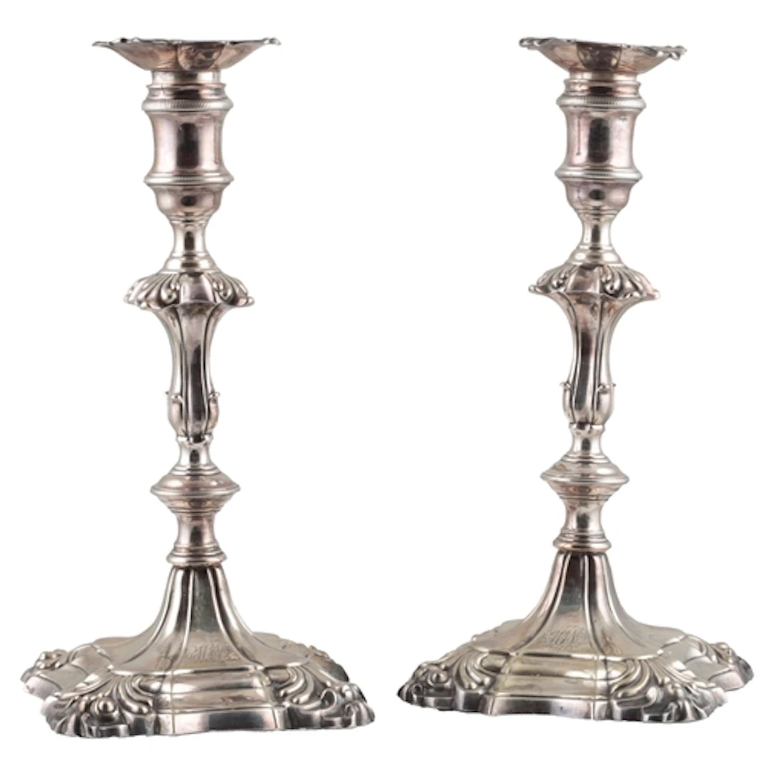 A pair of late George II cast silver candlesticks, by John Q...