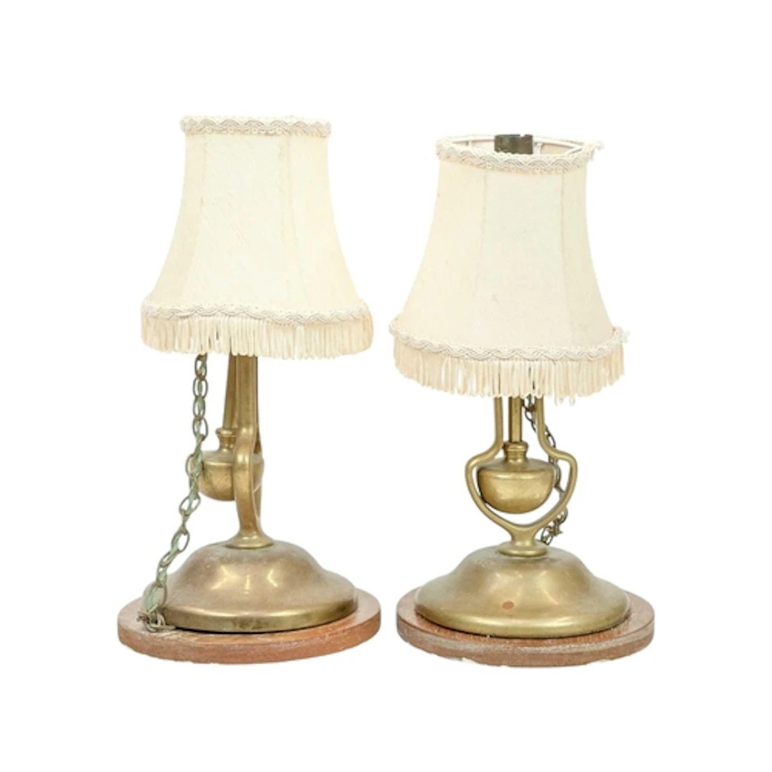 A pair of brass gimbal wall lights. The loaded bases attache...