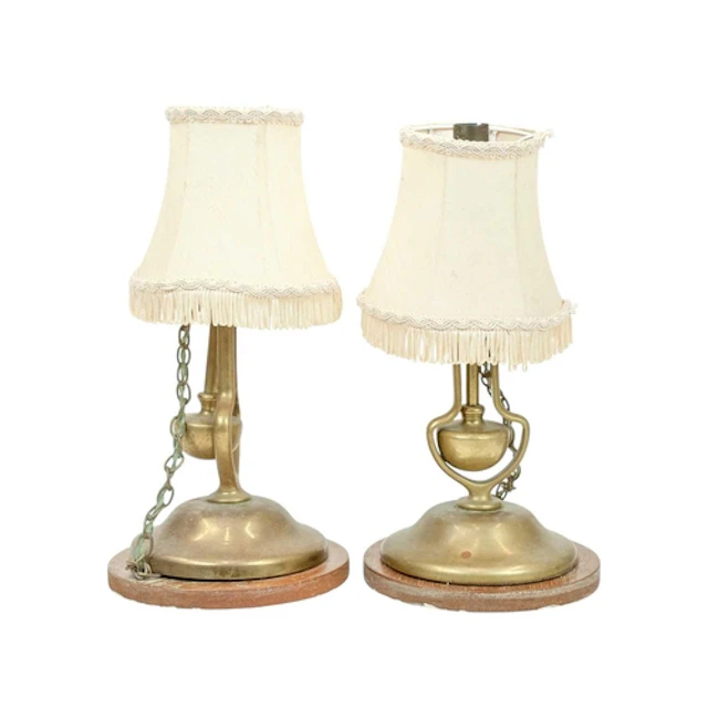 A pair of brass gimbal wall lights. The loaded bases attache...