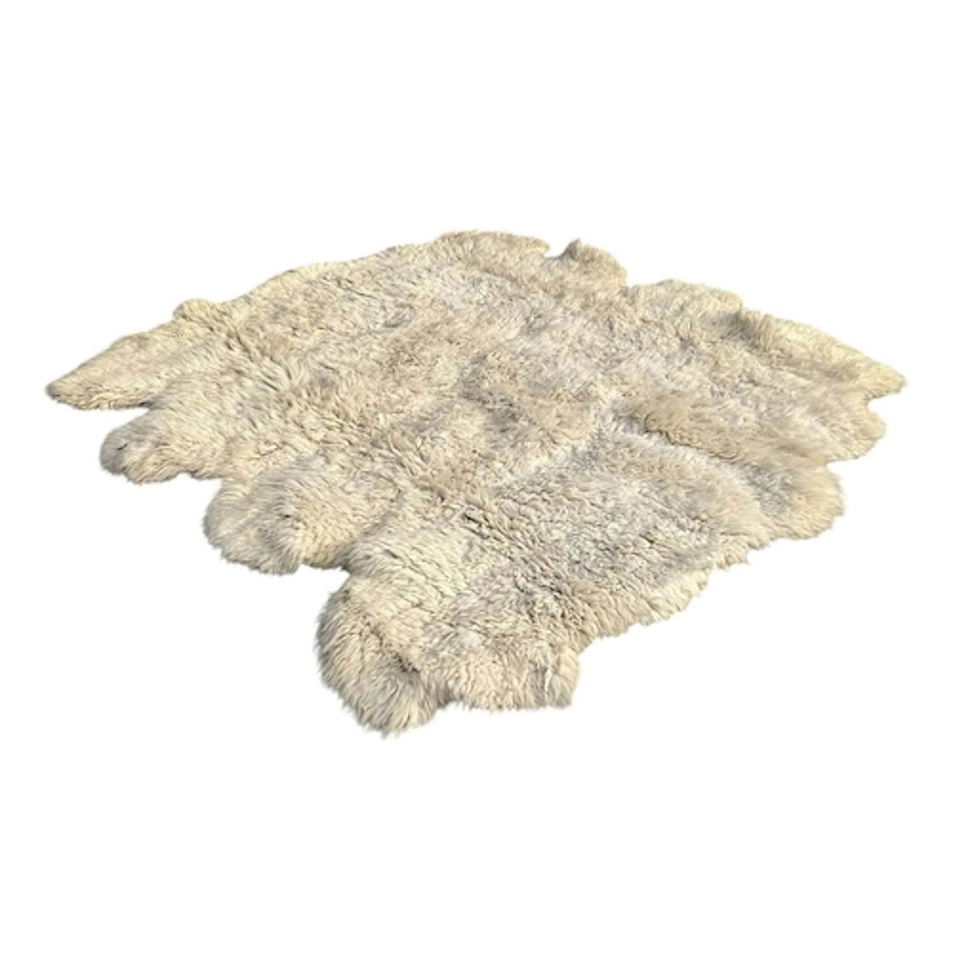 A large sheepskin hide rug. (Measures approx. 195 x 195cm)...