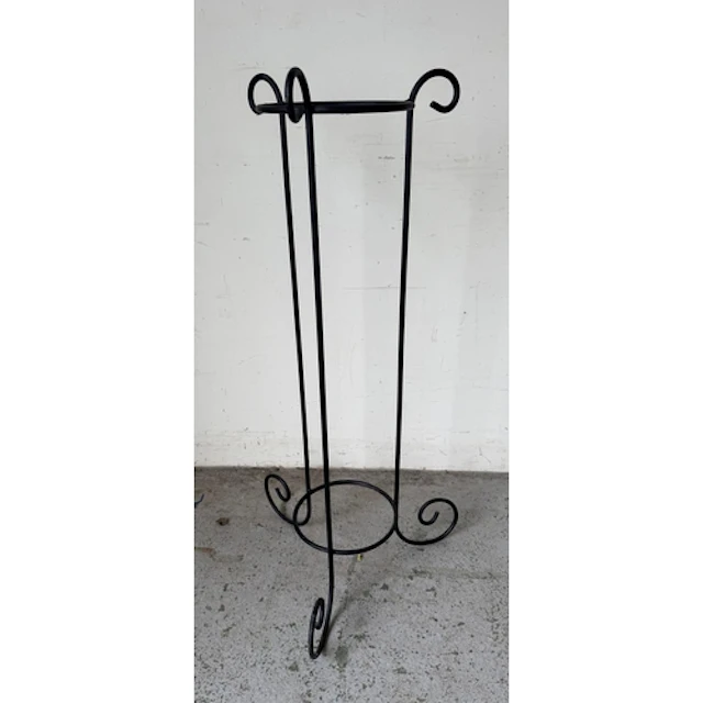 A cobalt blue glass planter on a black wrought iron stand. H...