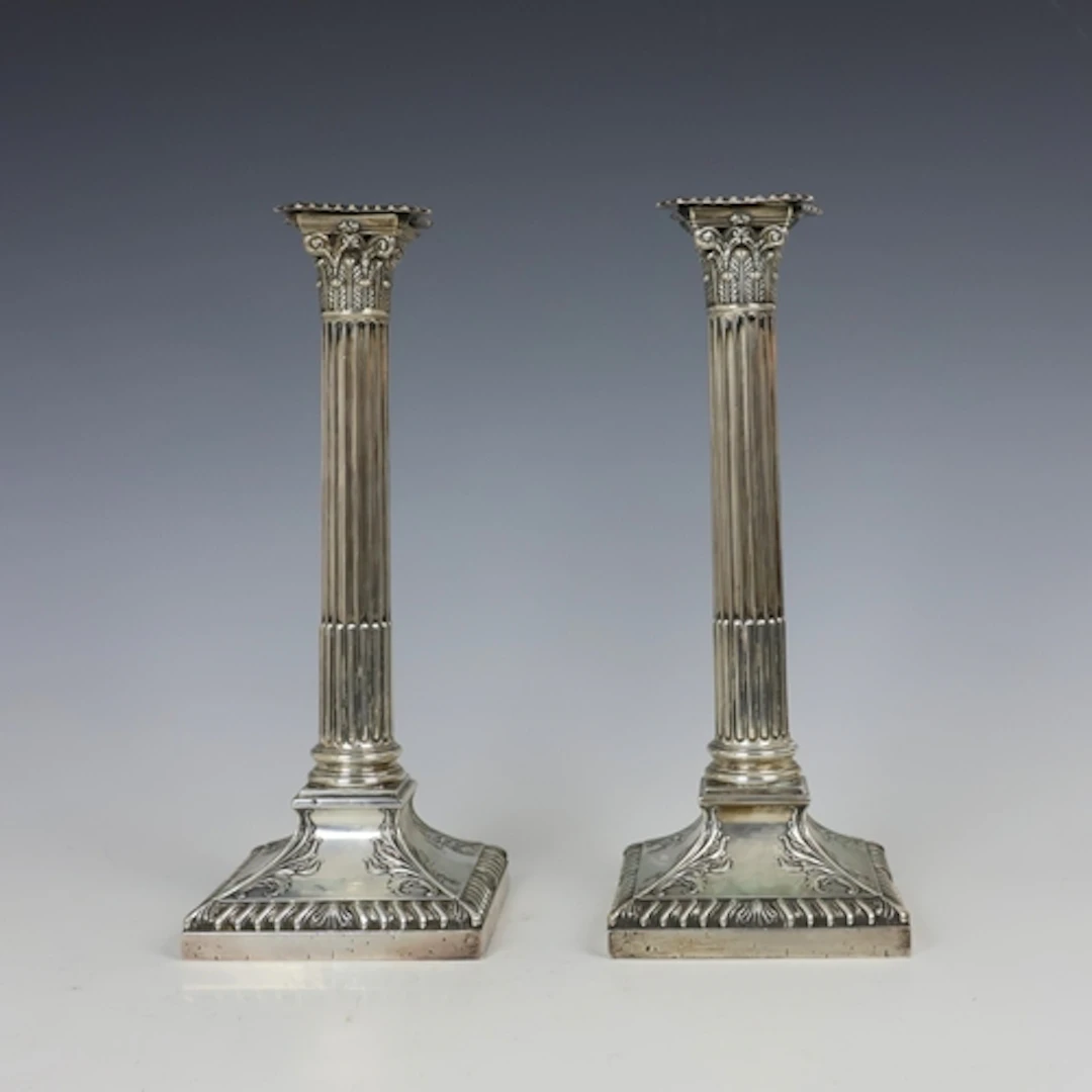 A pair of Edwardian silver mounted candlesticks, Thomas A Sc...