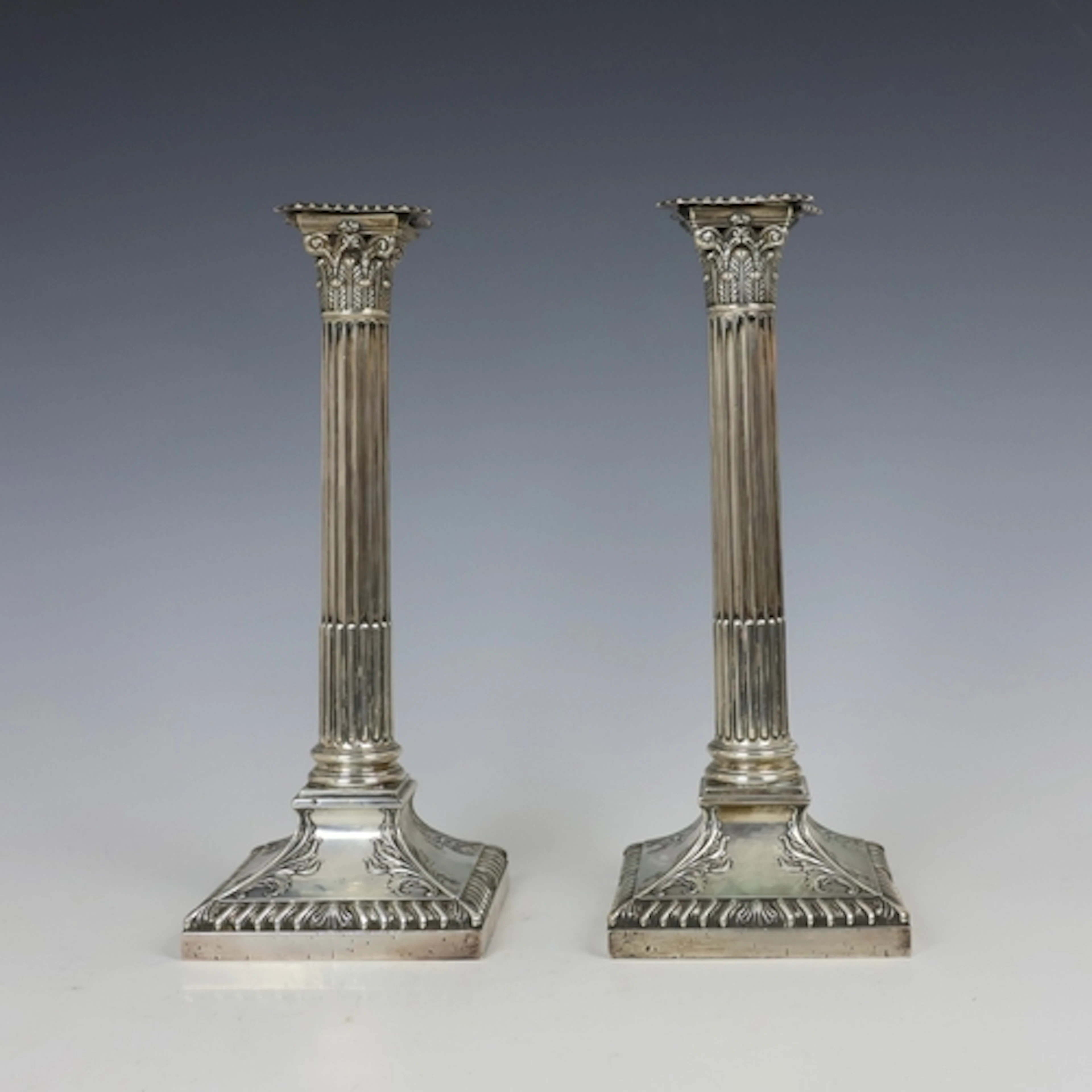 A pair of Edwardian silver mounted candlesticks, Thomas A Sc...