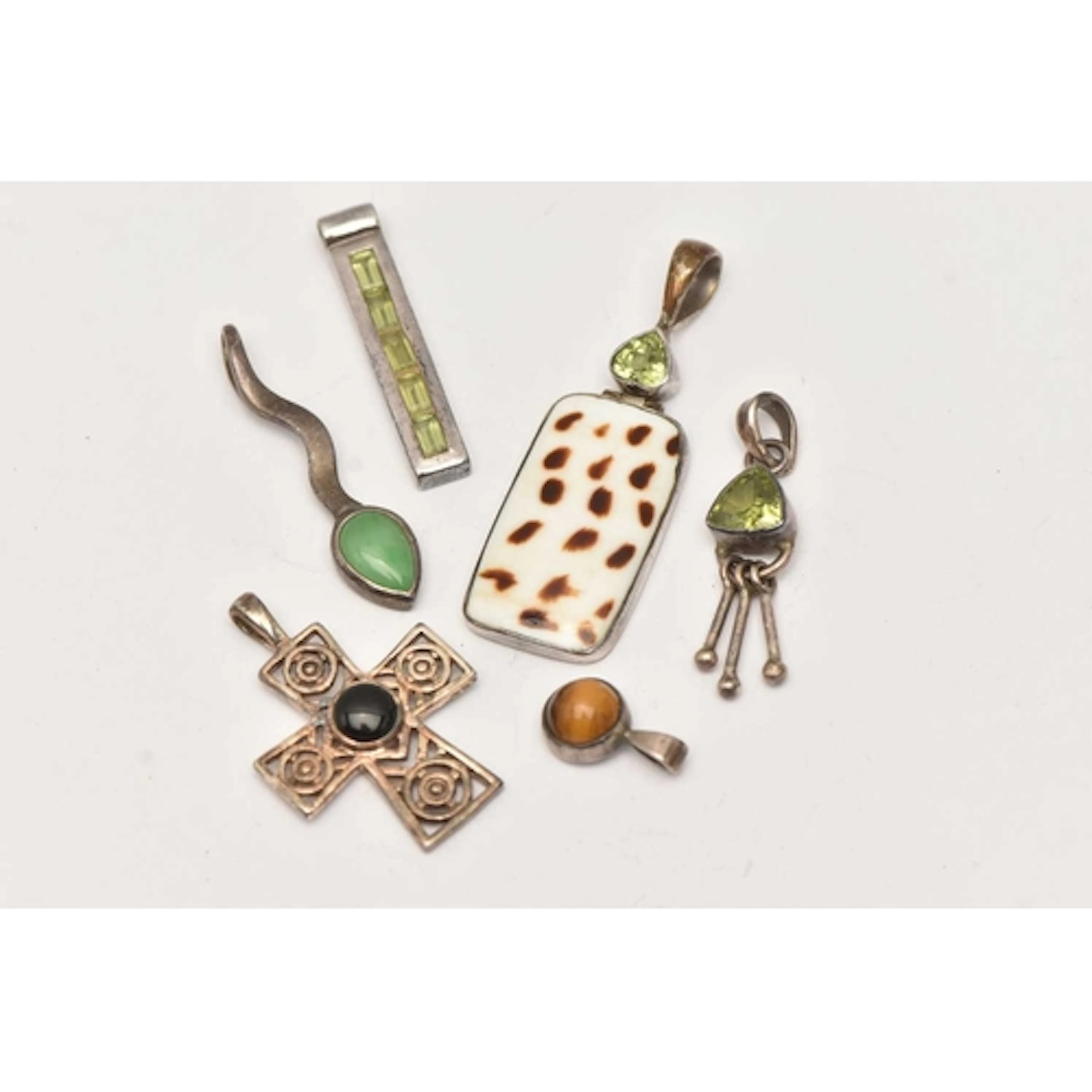 SIX WHITE METAL PENDANTS, various designs, set with semi-pre...