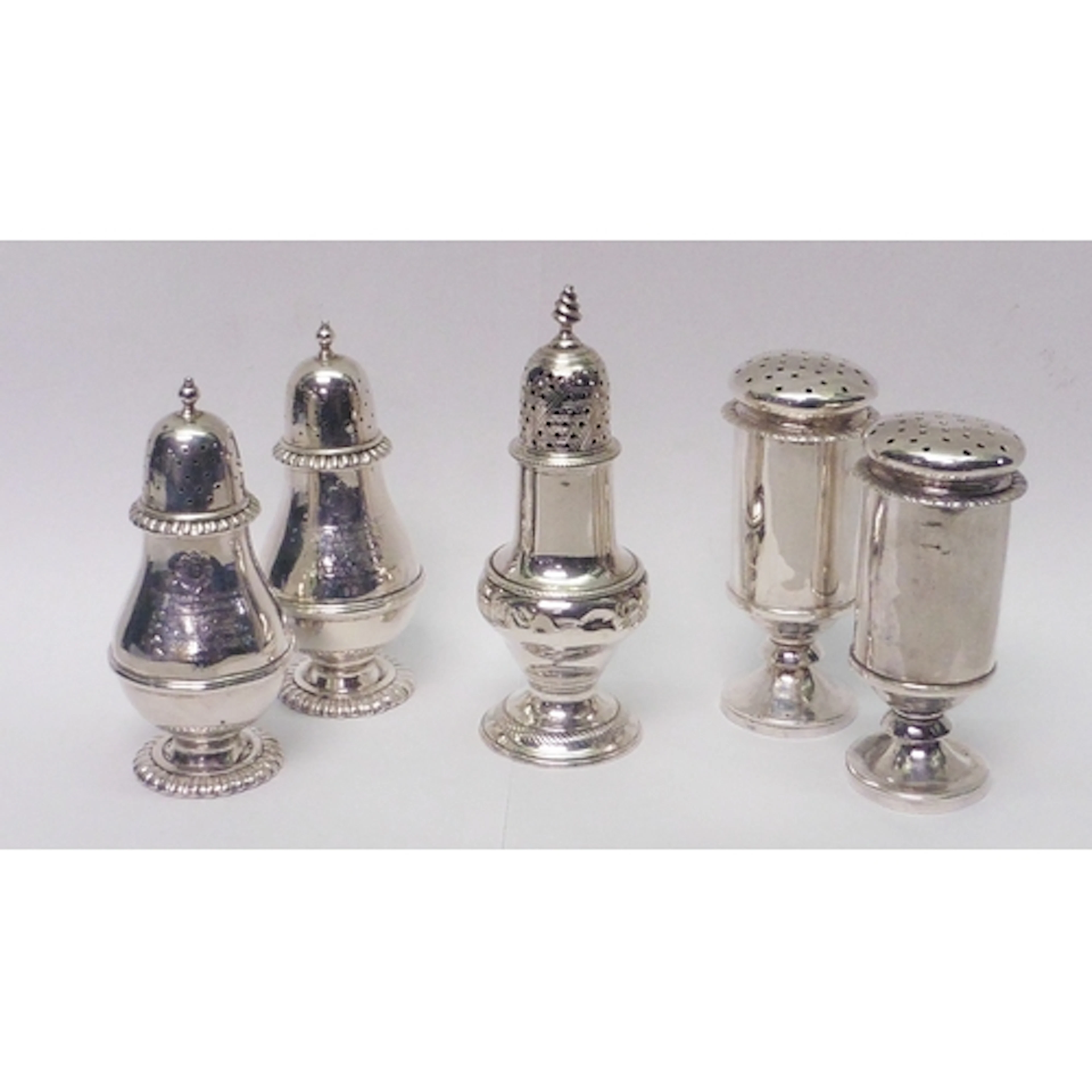 A pair of pounce pots, unmarked white metal, each 100mm tall...
