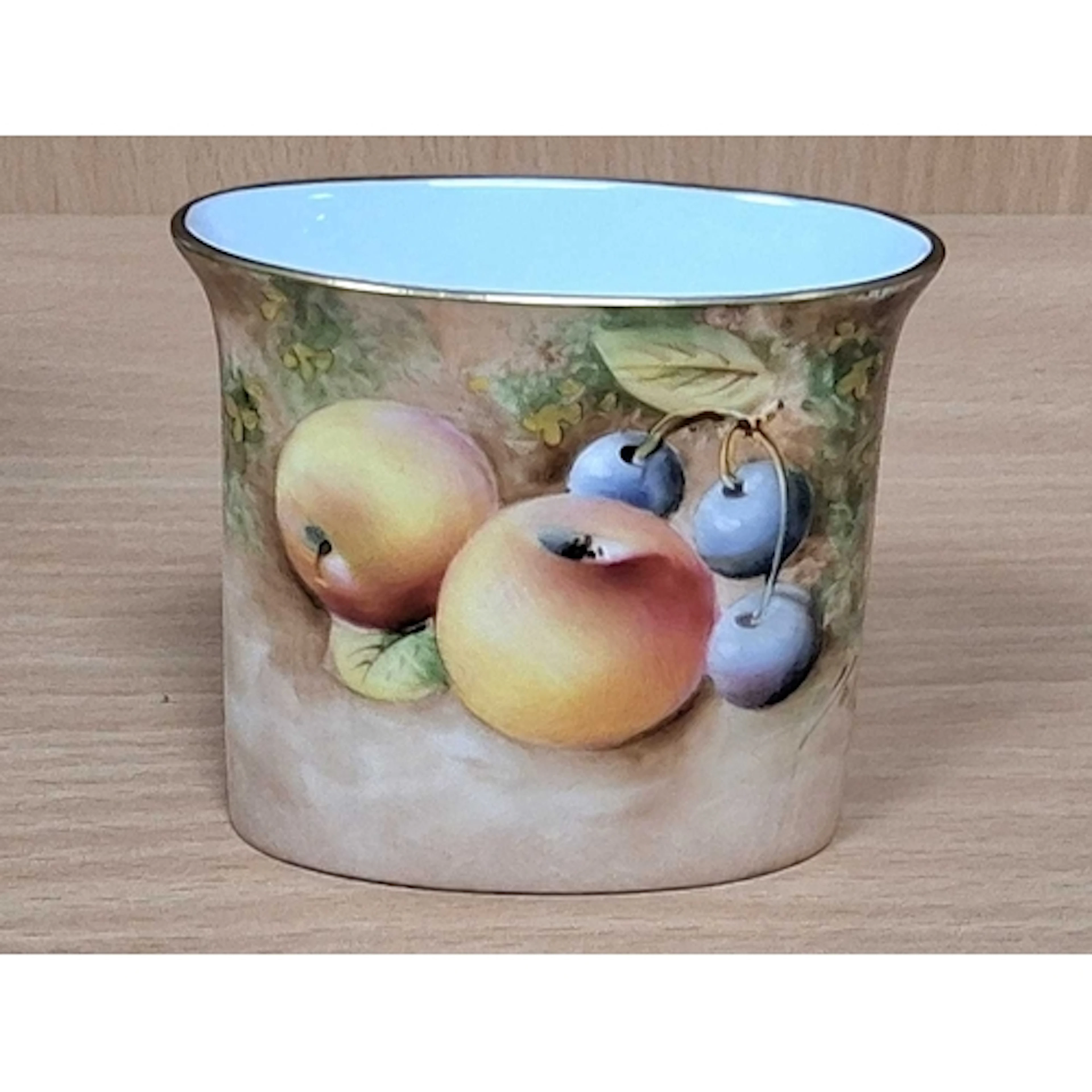 A ROYAL WORCESTER FALLEN FRUITS MATCH HOLDER, painted with a...