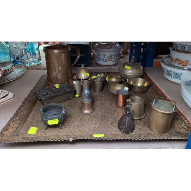 A group of copper and brass wares, including a stamped jug, ...