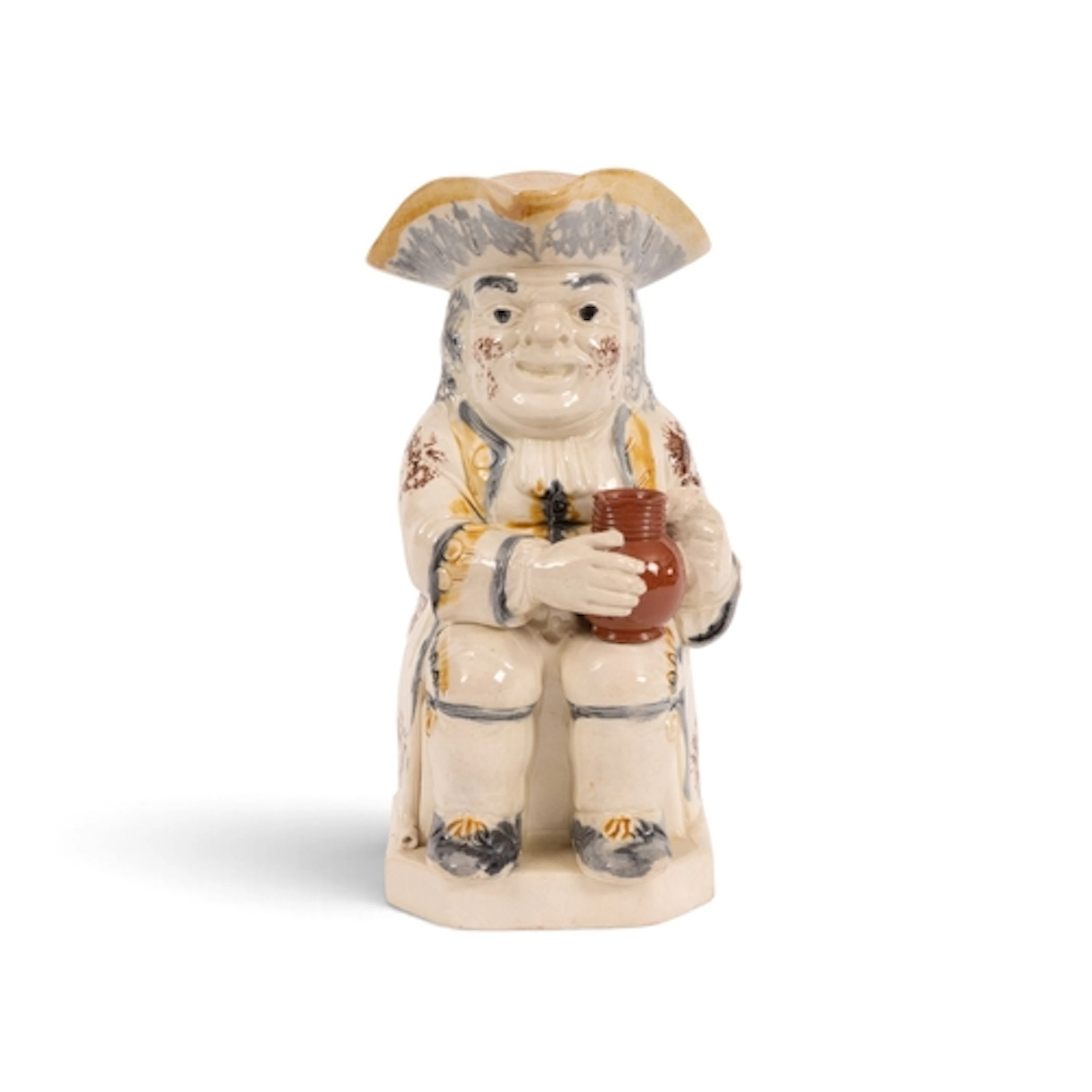 A good creamware Toby jug, c.1800, of Ordinary type, seated ...