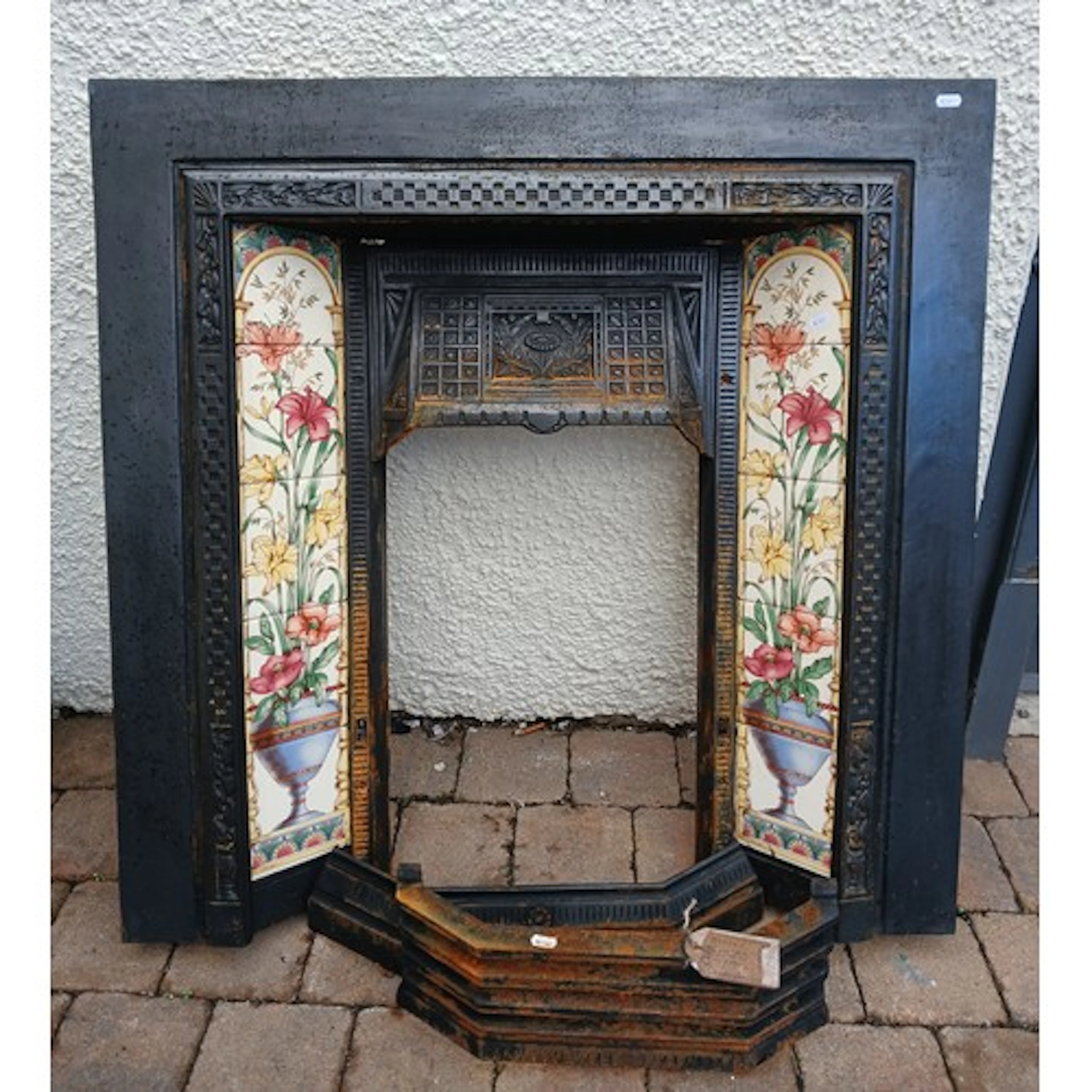 Cast iron fireplace with decorative tiles.