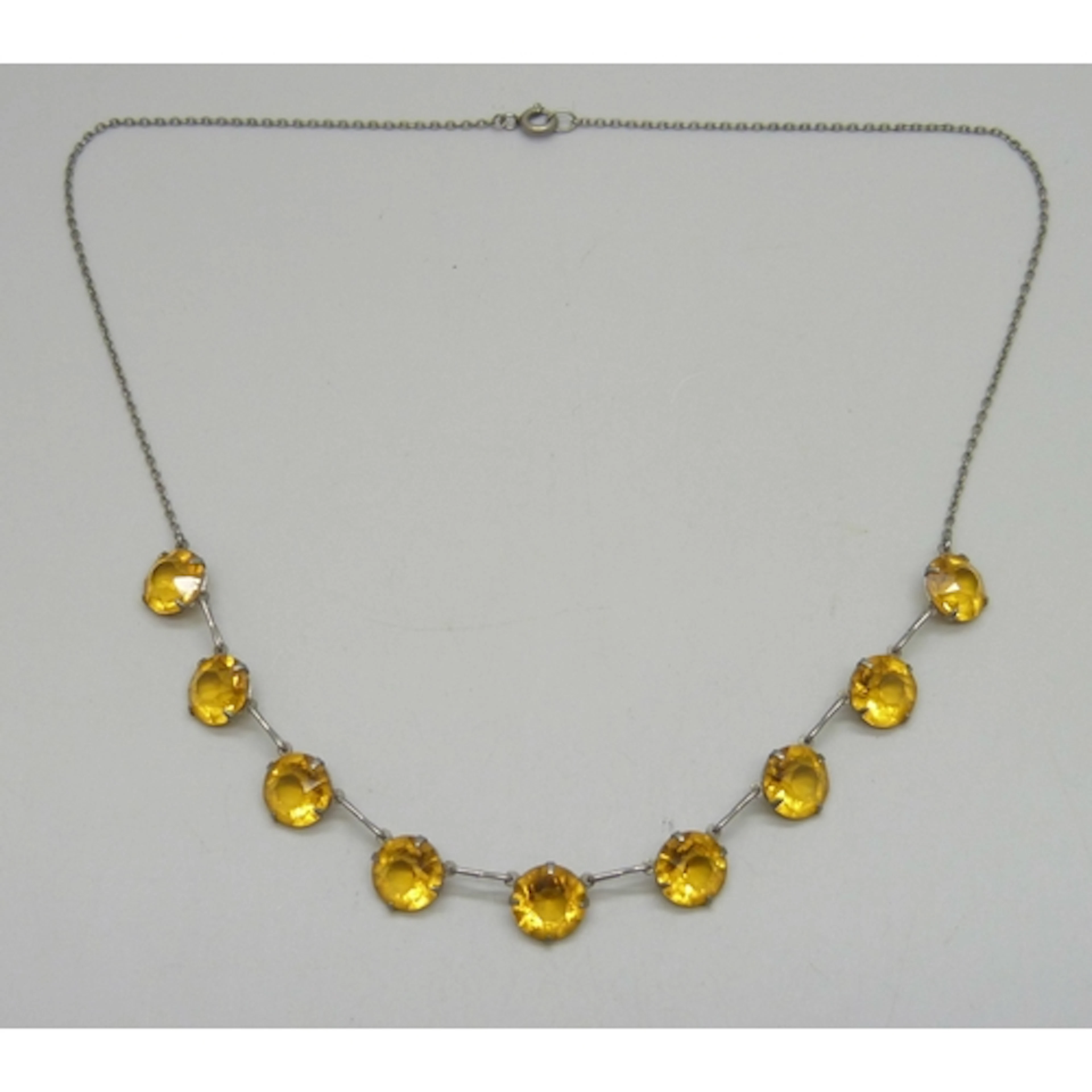 A half riviere necklace set with yellow paste stones, 40cm, ...