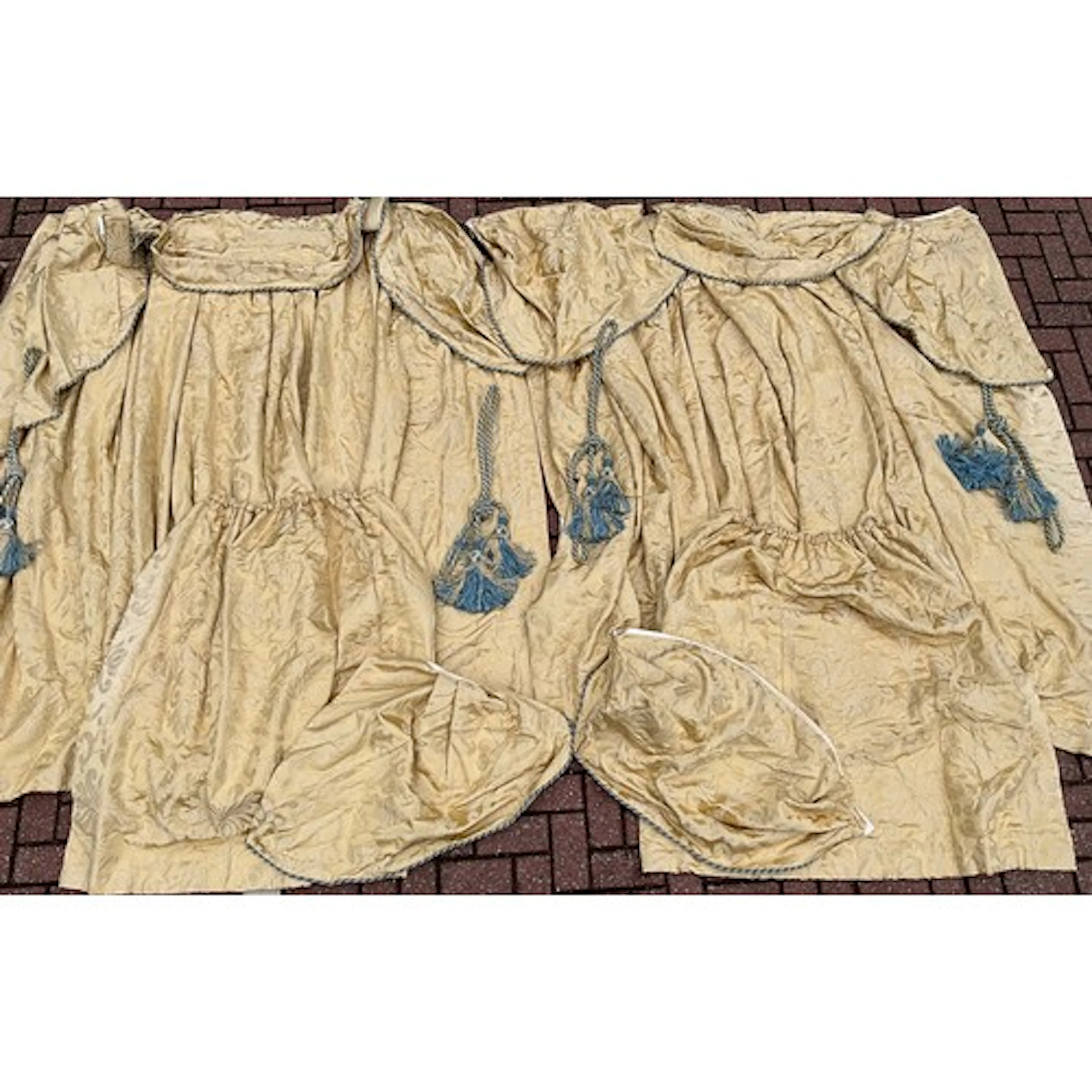 An elaborate pair of cream silk damask curtains, baroque aca...