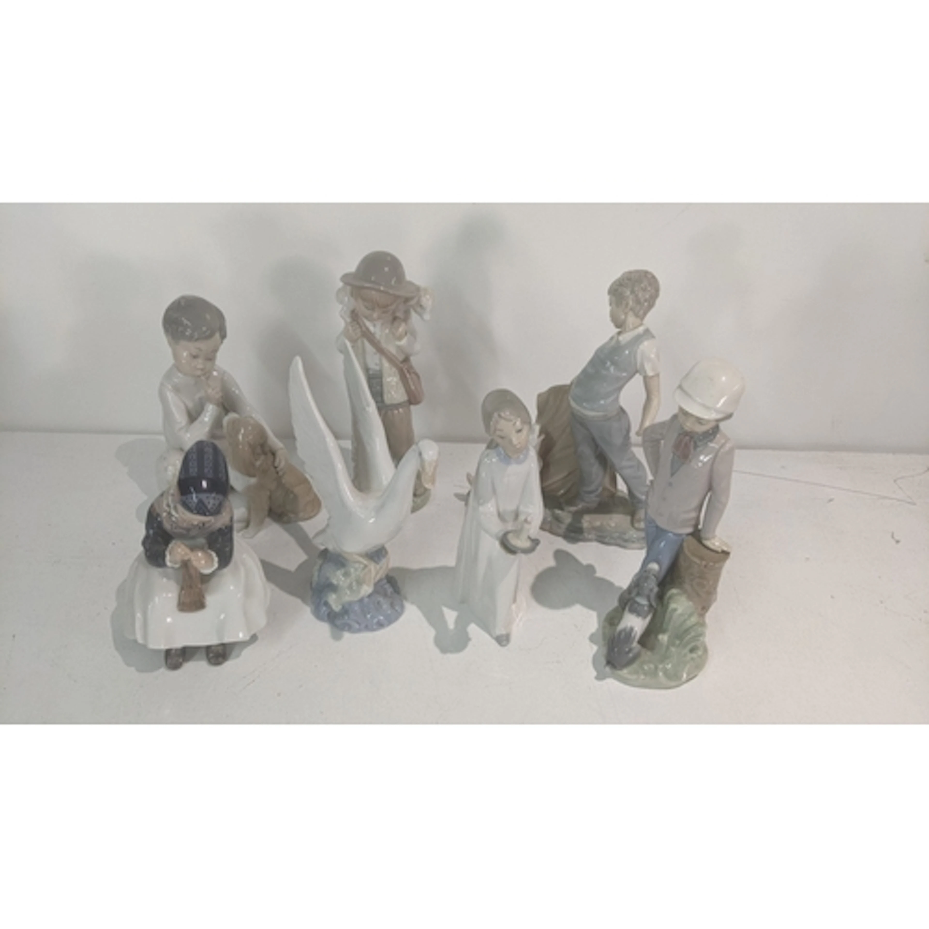 Porcelain figures to include a Lladro 4522 'Shhh, Quiet Pupp...