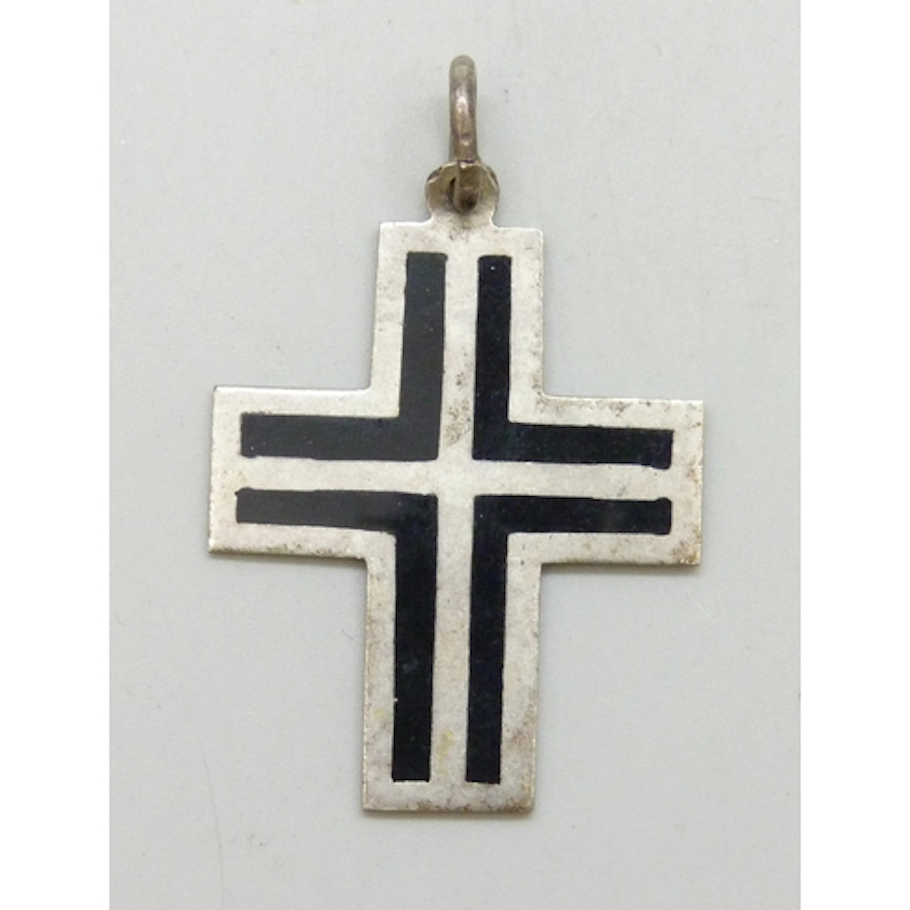 A silver Modernist cross design necklace pendant set with bl...