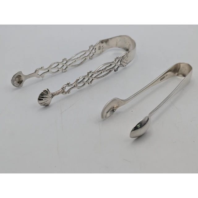 Two sugar tongs, one decorated with a coat of arms, hallmark...