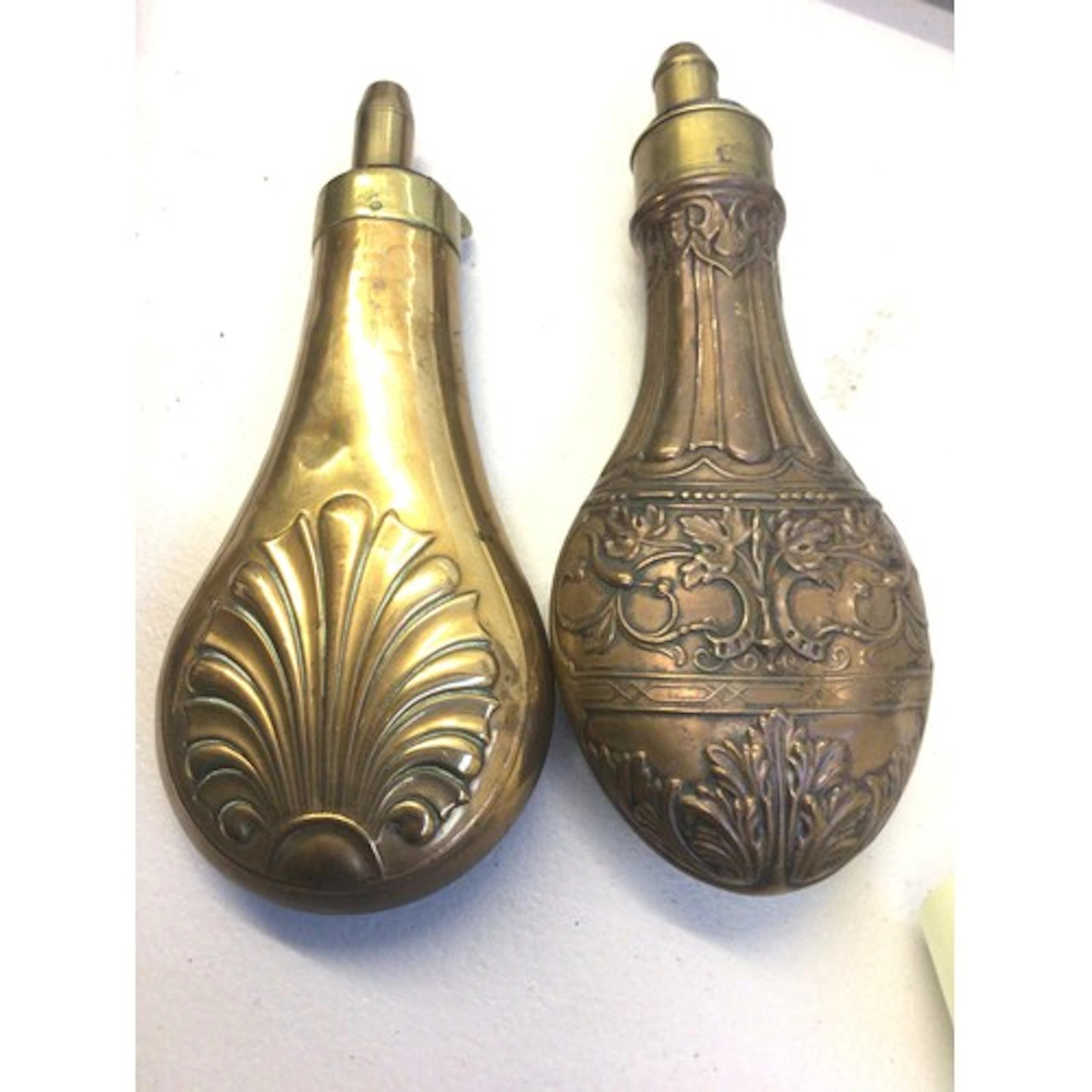Two 19th century brass and copper powder flasks Repousse cha...