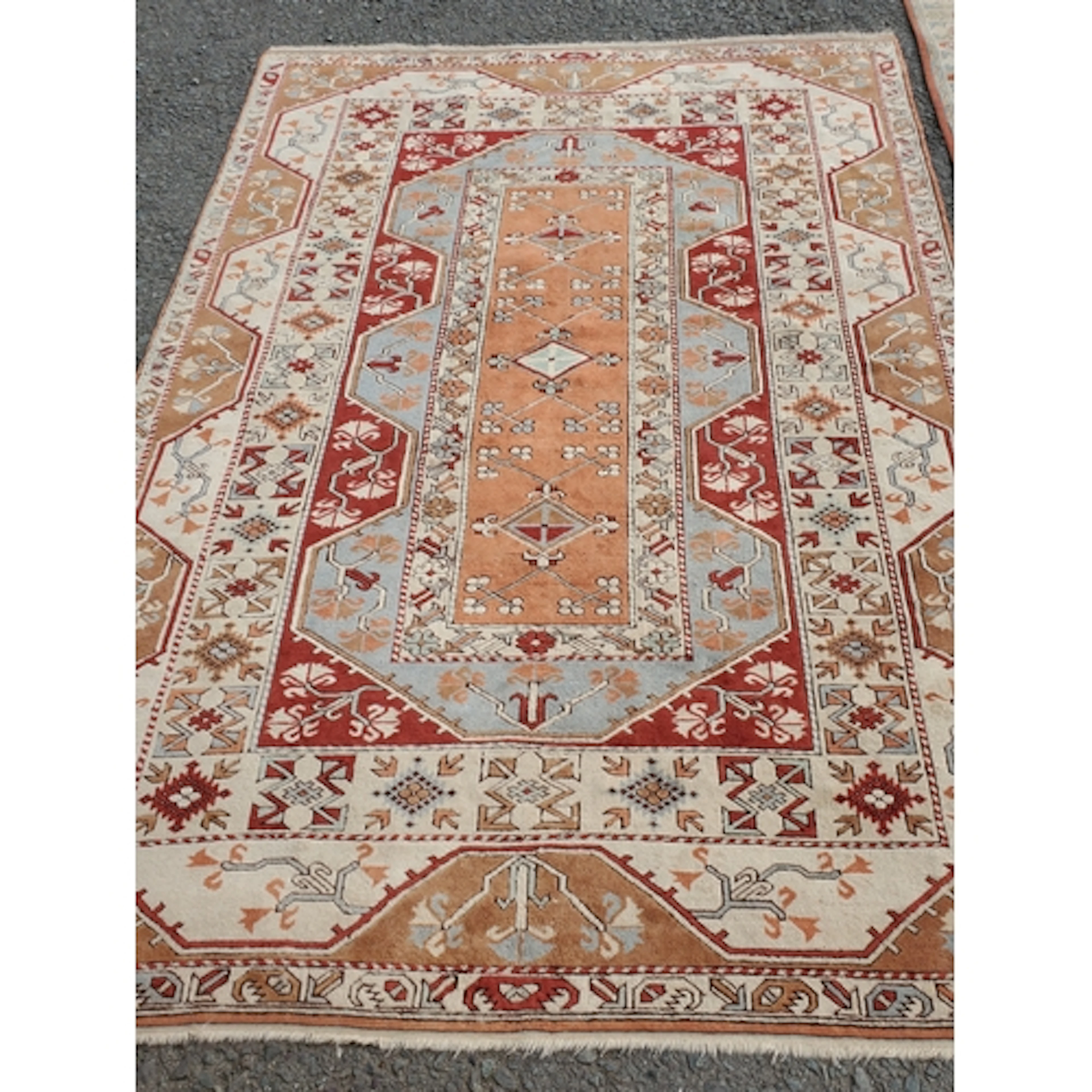 A terracotta ground woolen Rug with terracotta and turquoise...