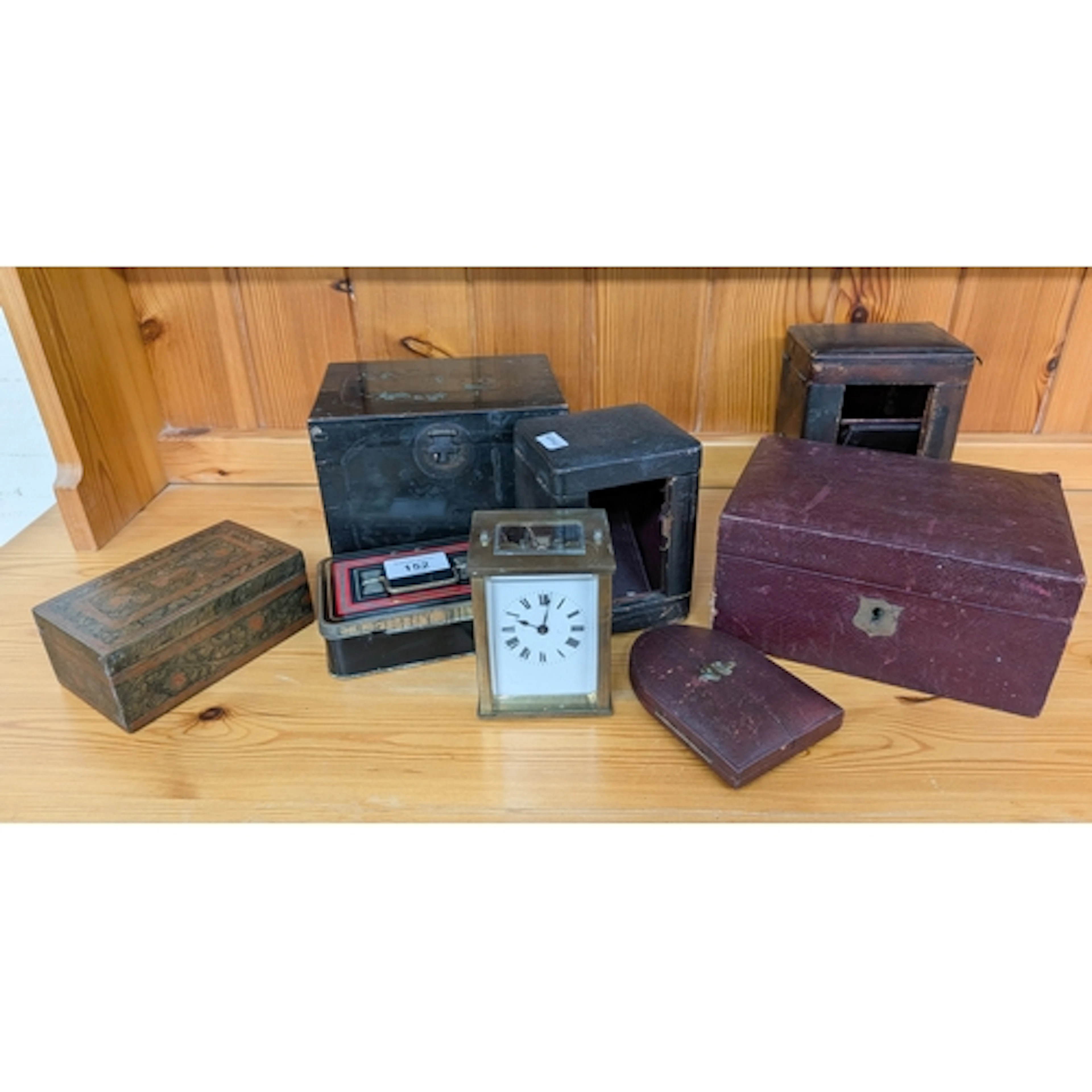A brass carriage clock with two leather cases and leather je...