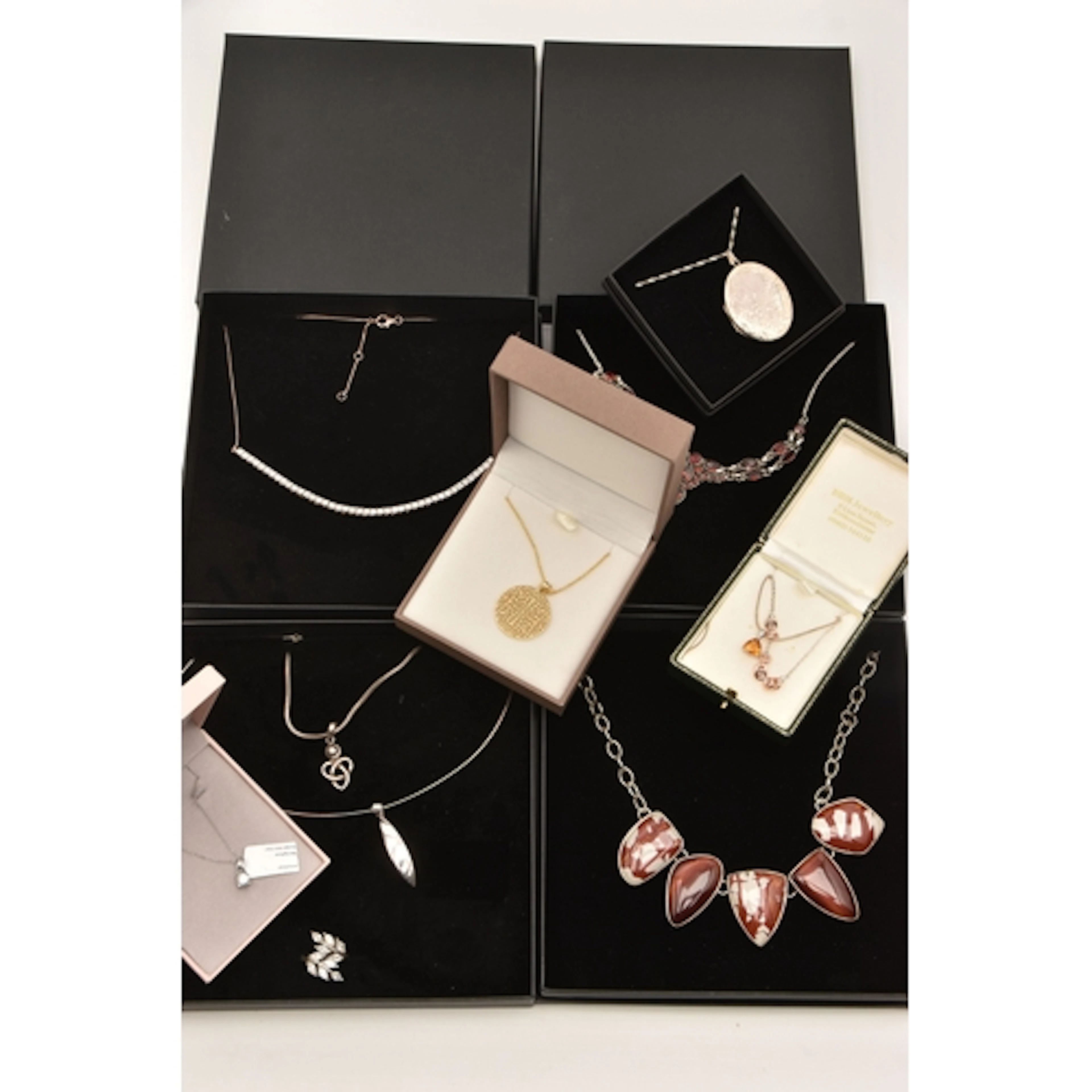 A PLASTIC BOX OF JEWELLERY, to include a boxed silver CZ nec...