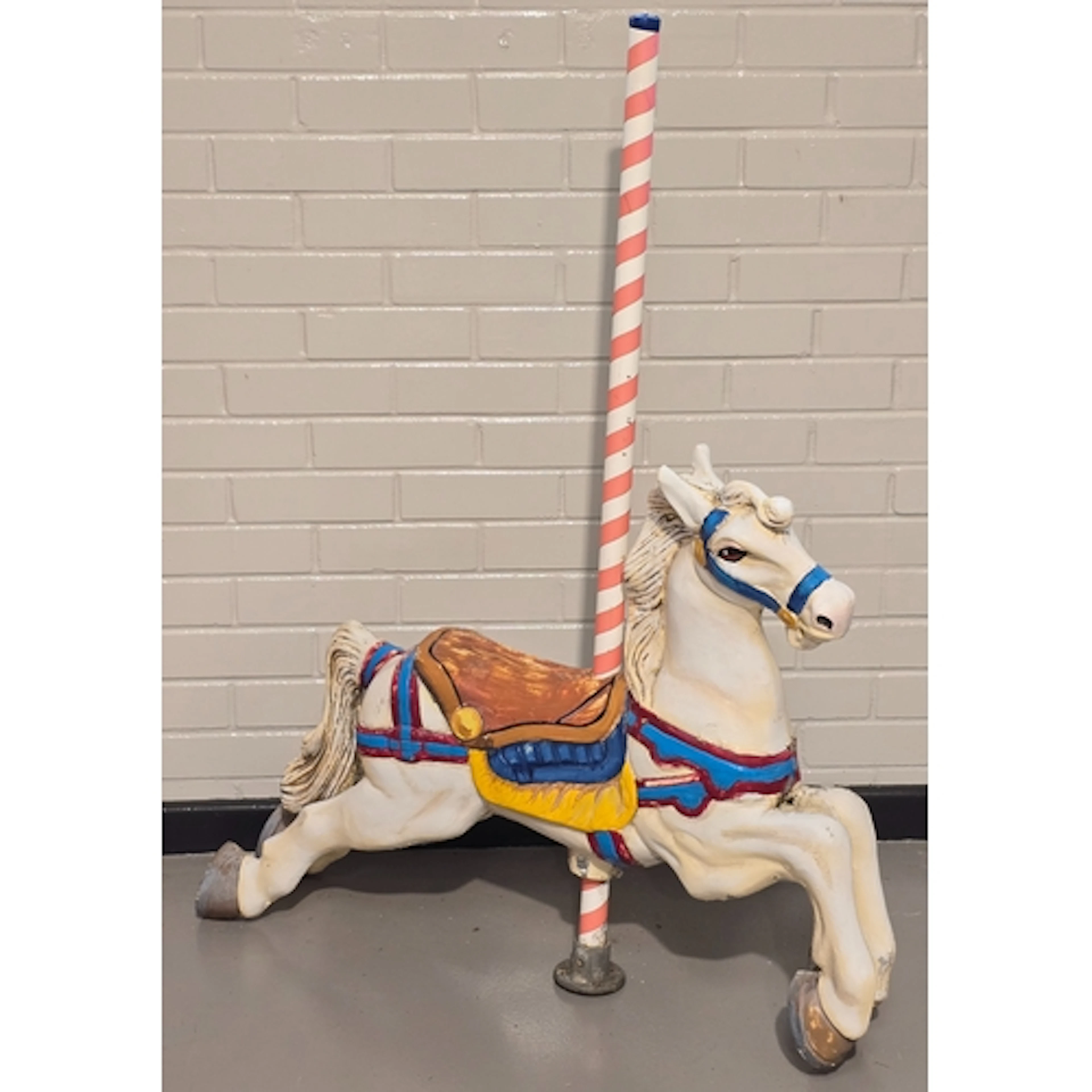 A vintage metal painted merry-go-round horse with pole. Pole...