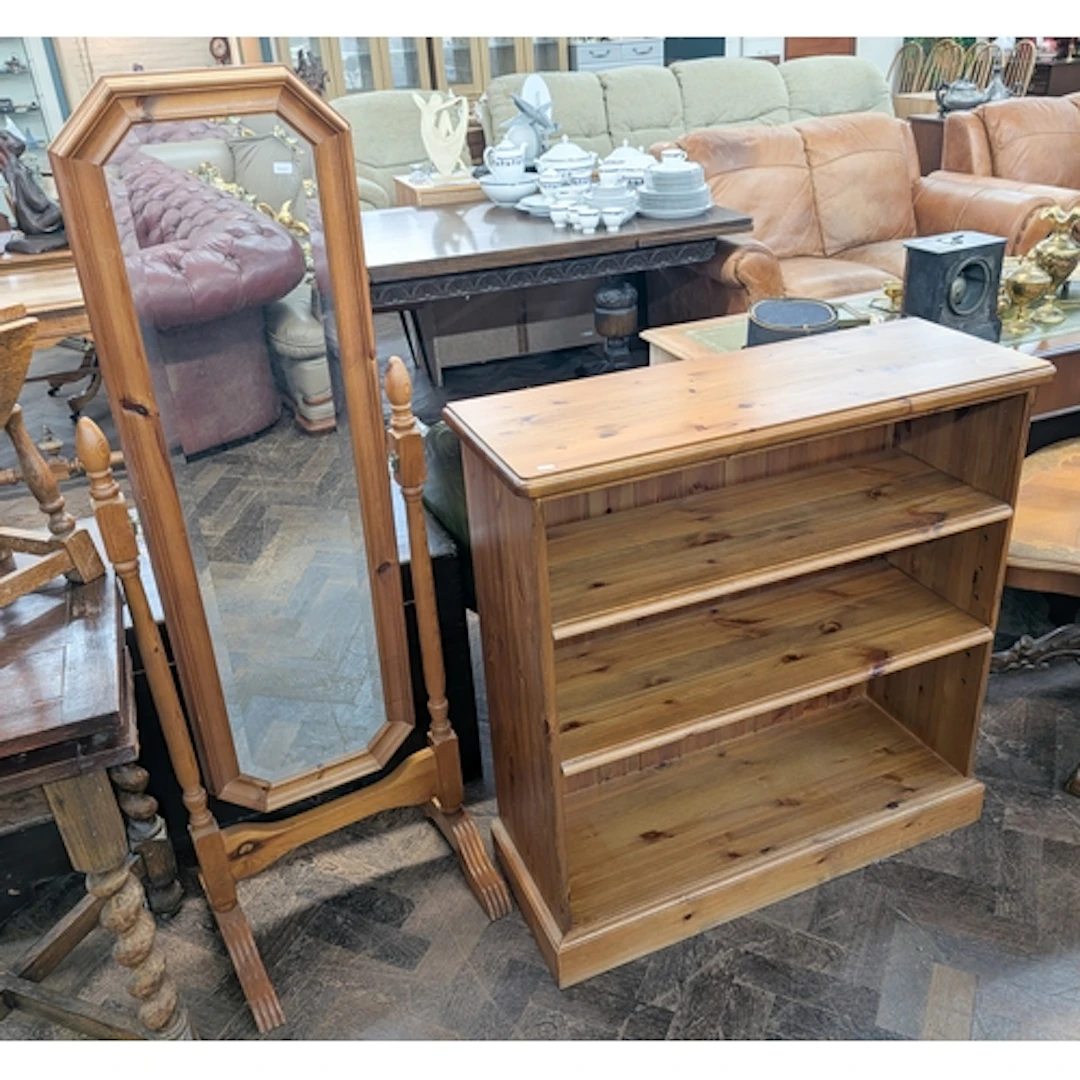 A low pine open bookcase and a pine framed cheval dressing m...