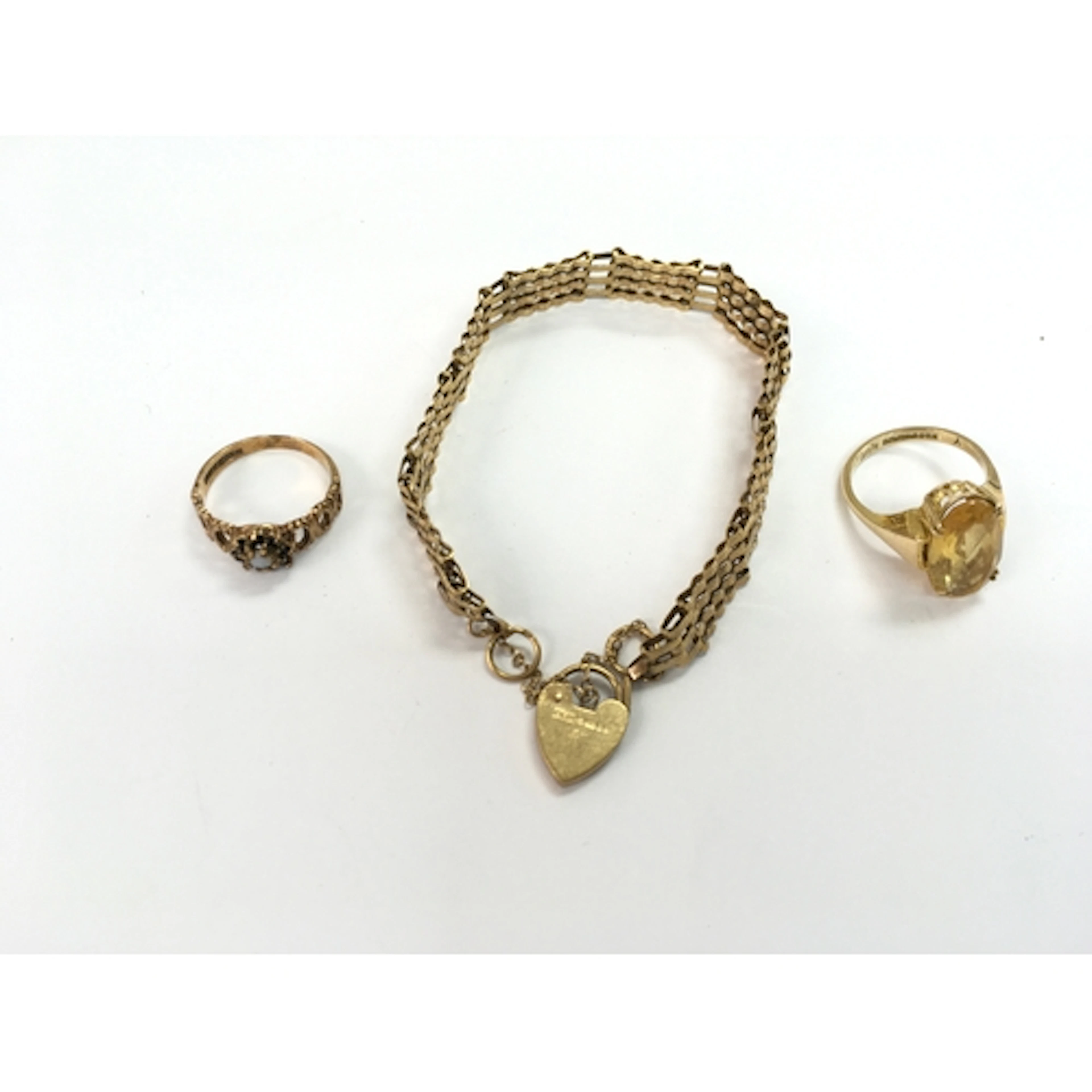 Two 9ct gold rings and a 9ct gold bracelet. 14g total ...