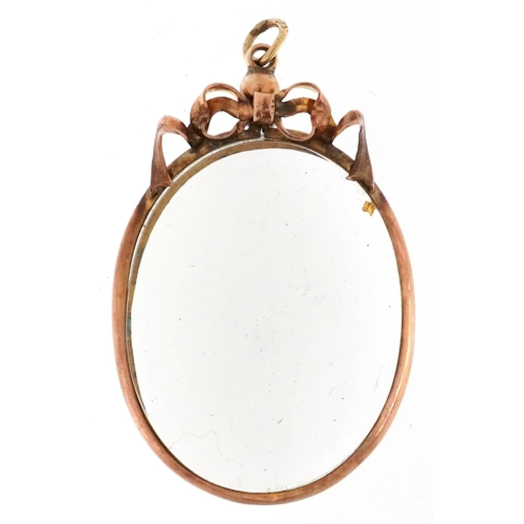 Edwardian 9ct gold open locket with bow crest, 5.1cm high, 1...