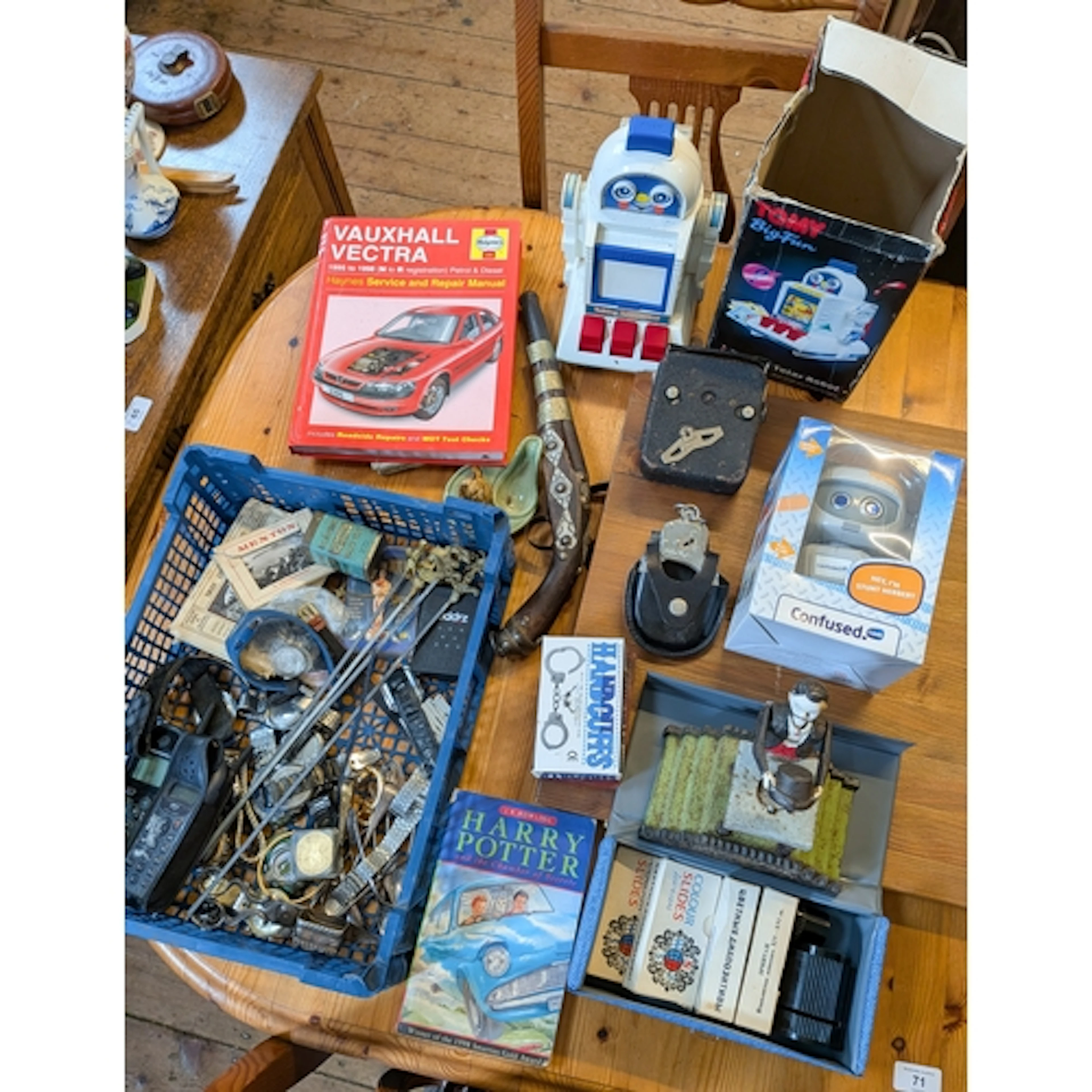 A collection of various watches and mobile phones, handcuffs...
