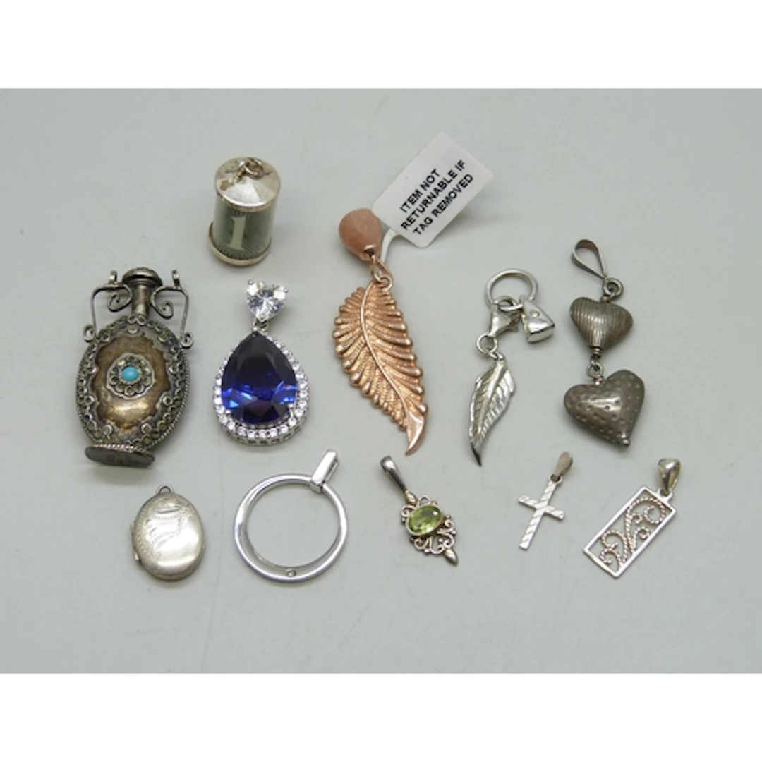 A collection of silver and white metal pendants, 43g