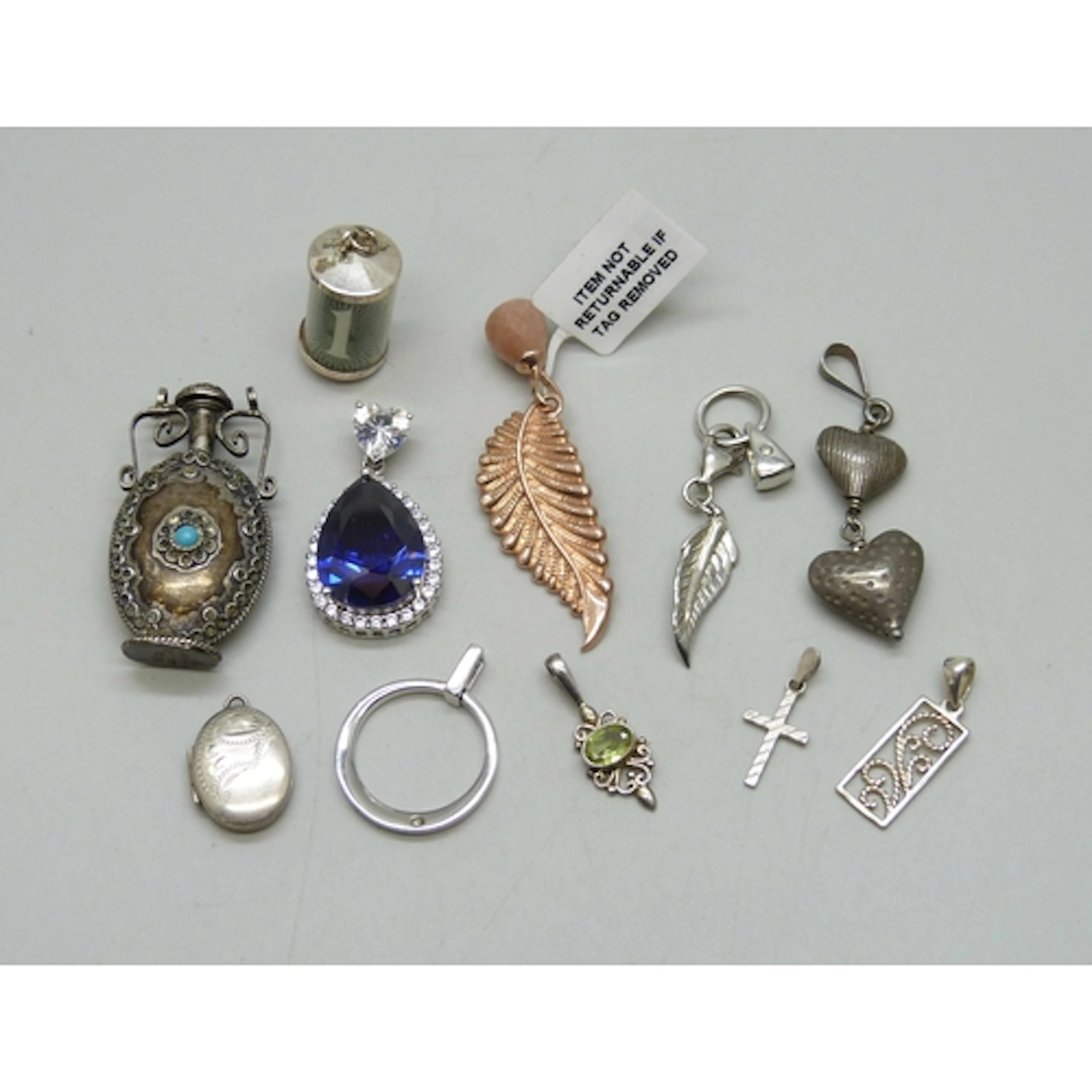 A collection of silver and white metal pendants, 43g