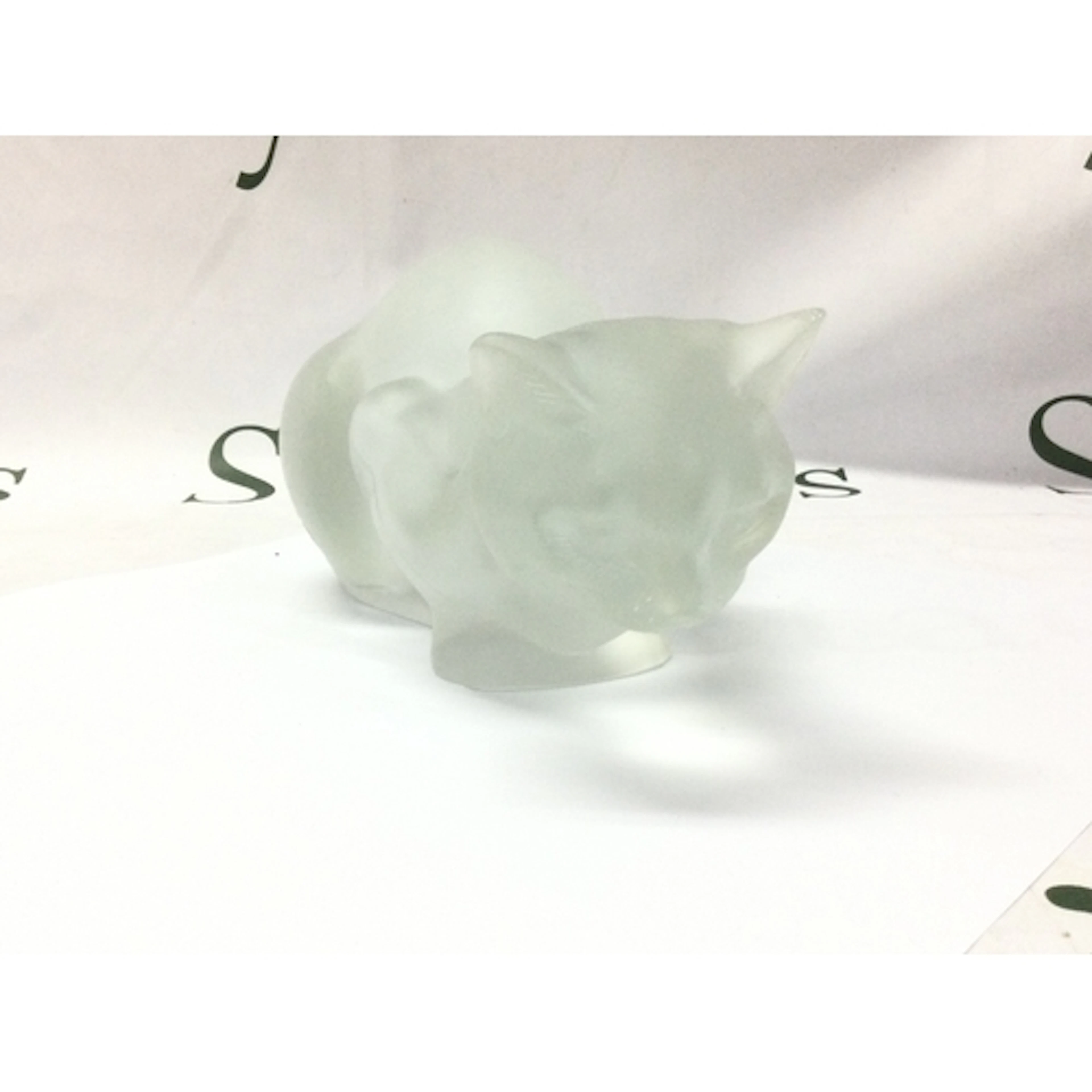 A Lalique cat sculpture. Small chip noted on ear. Approximat...