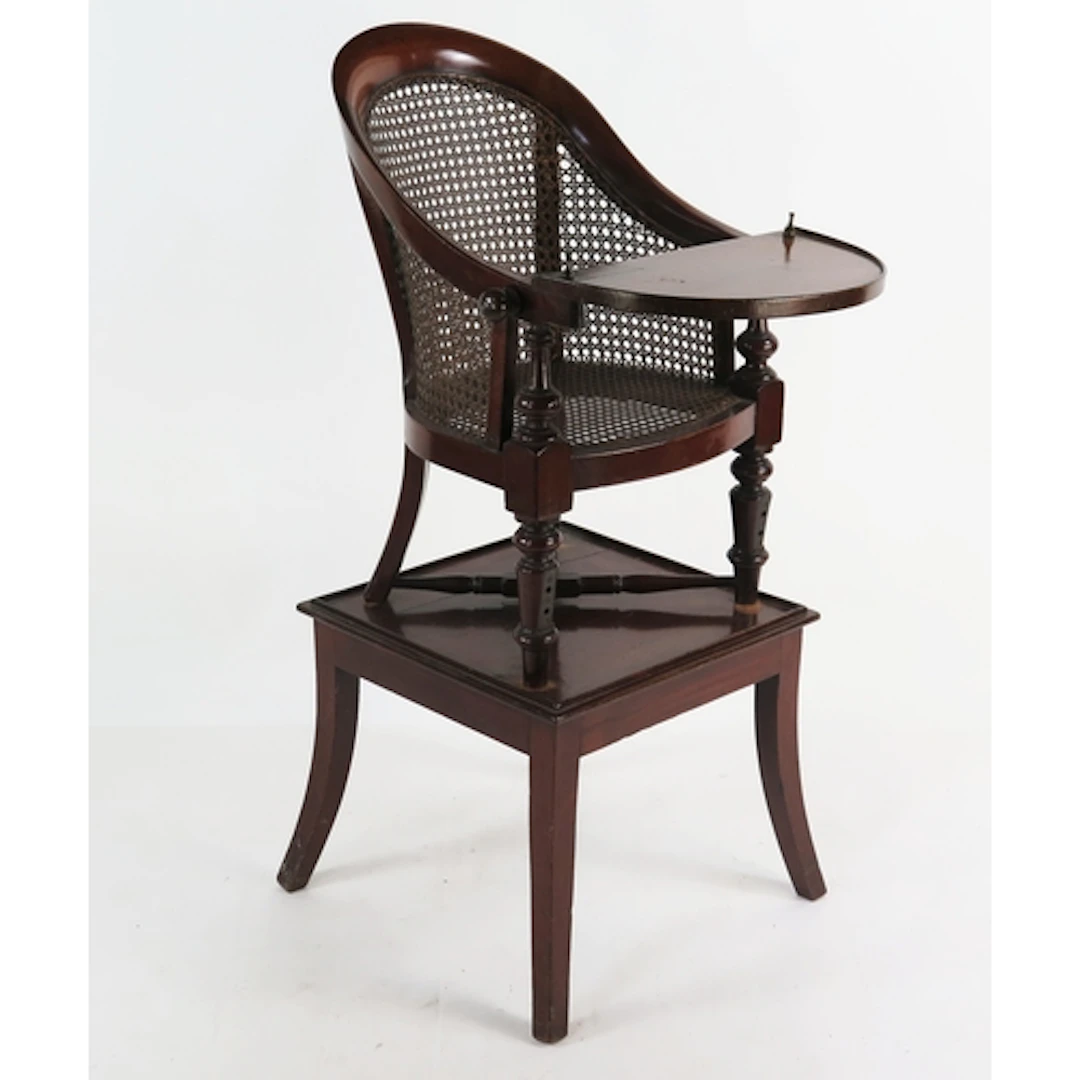 A George III mahogany child's high chair, with cane panel ba...