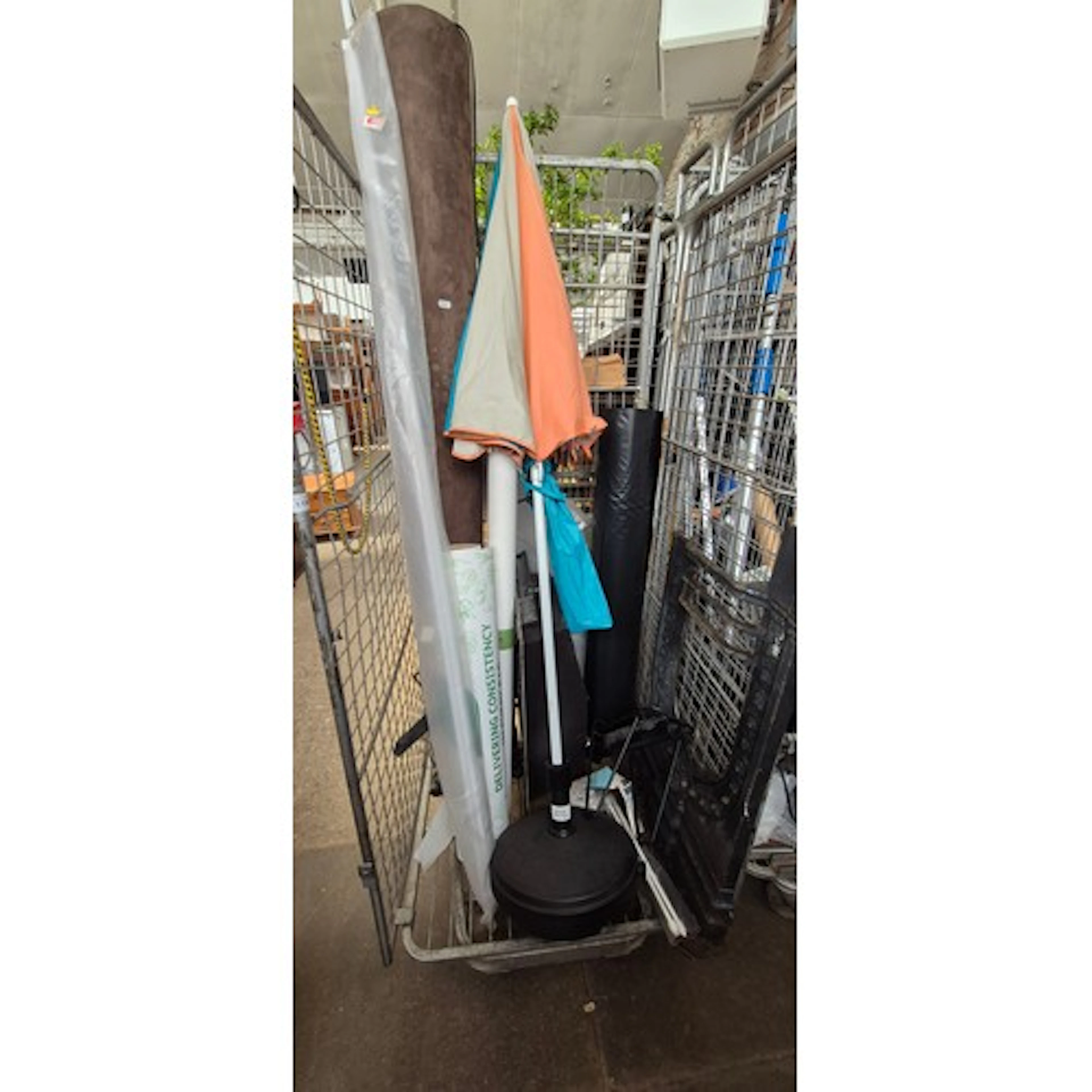 A cage (NOT INCLUDED IN SALE) containing parasol and base, c...