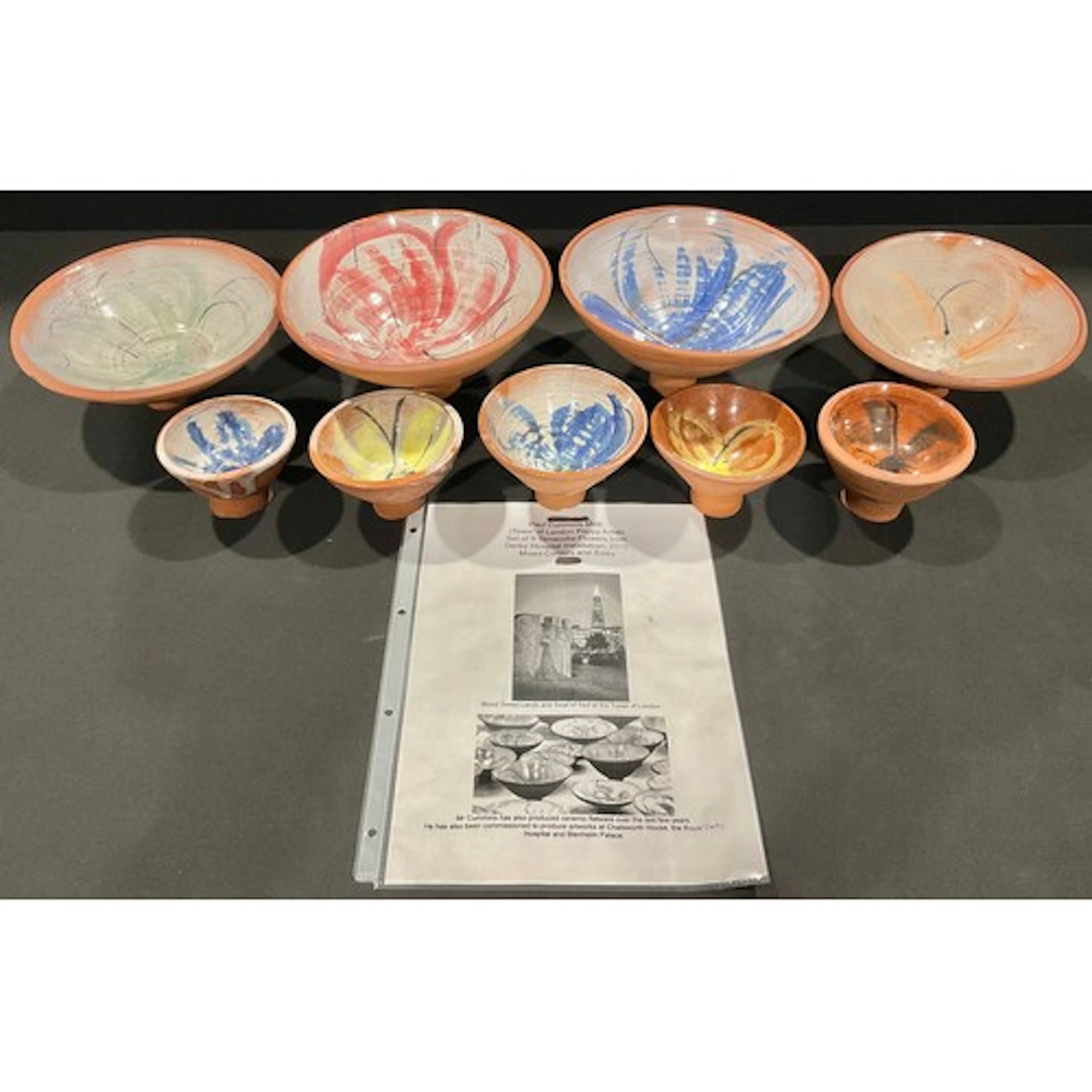 Paul Cummins MBE - A set of nine hand-thrown terracotta flow...