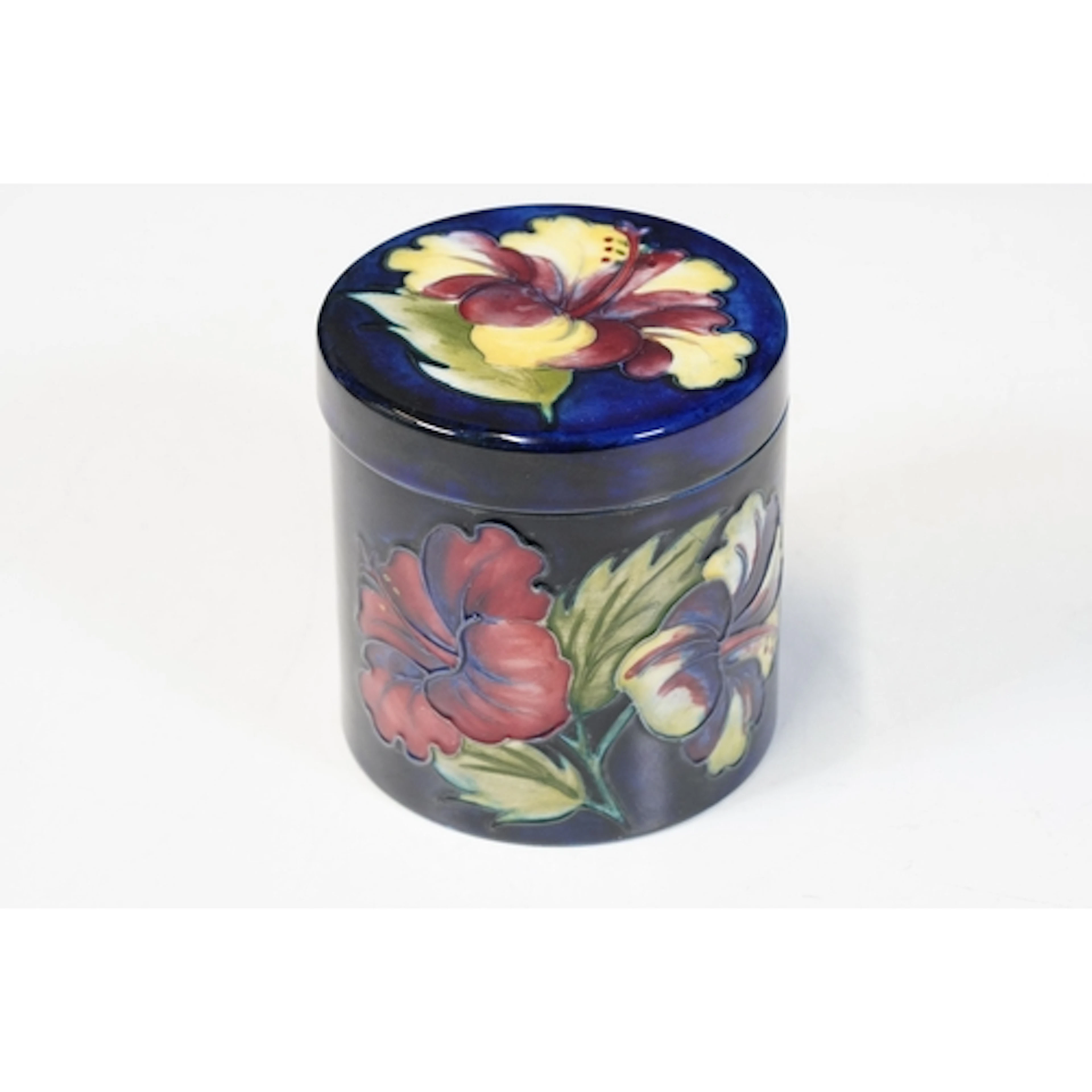 Moorcroft 'Hibiscus' pattern lidded cylindrical jar, designe...