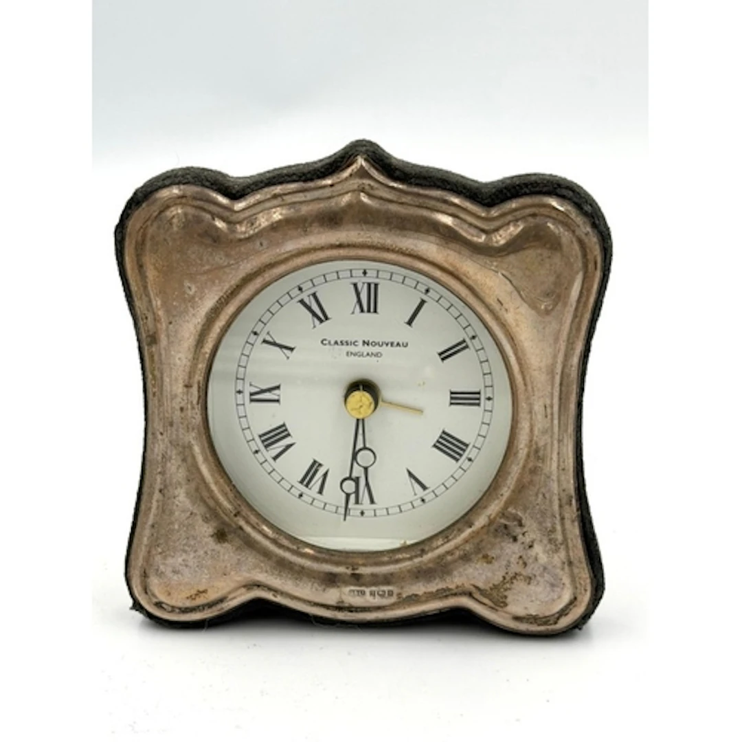 A contemporary, battery operated silver framed clock, hallma...