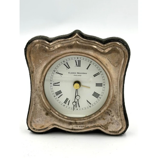 A contemporary, battery operated silver framed clock, hallma...
