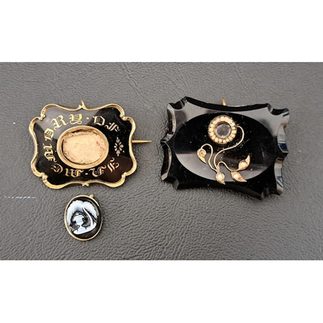 TWO VICTORIAN MOUNRING BROOCH/PENDANTS one with central hard...